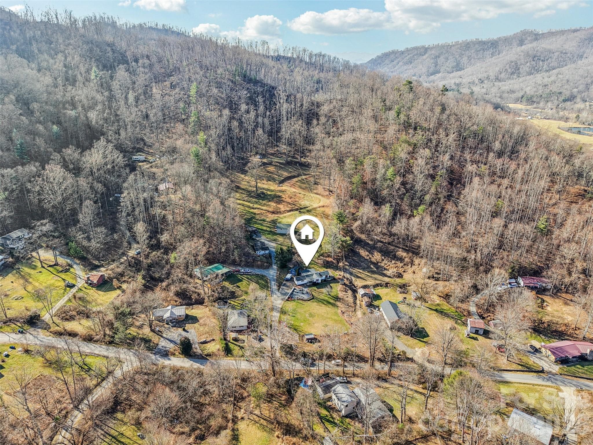 Aerial view of the property showing the surrounding neighborhood and mountain setting - 7 Landon Mountain Lane, Weaverville
