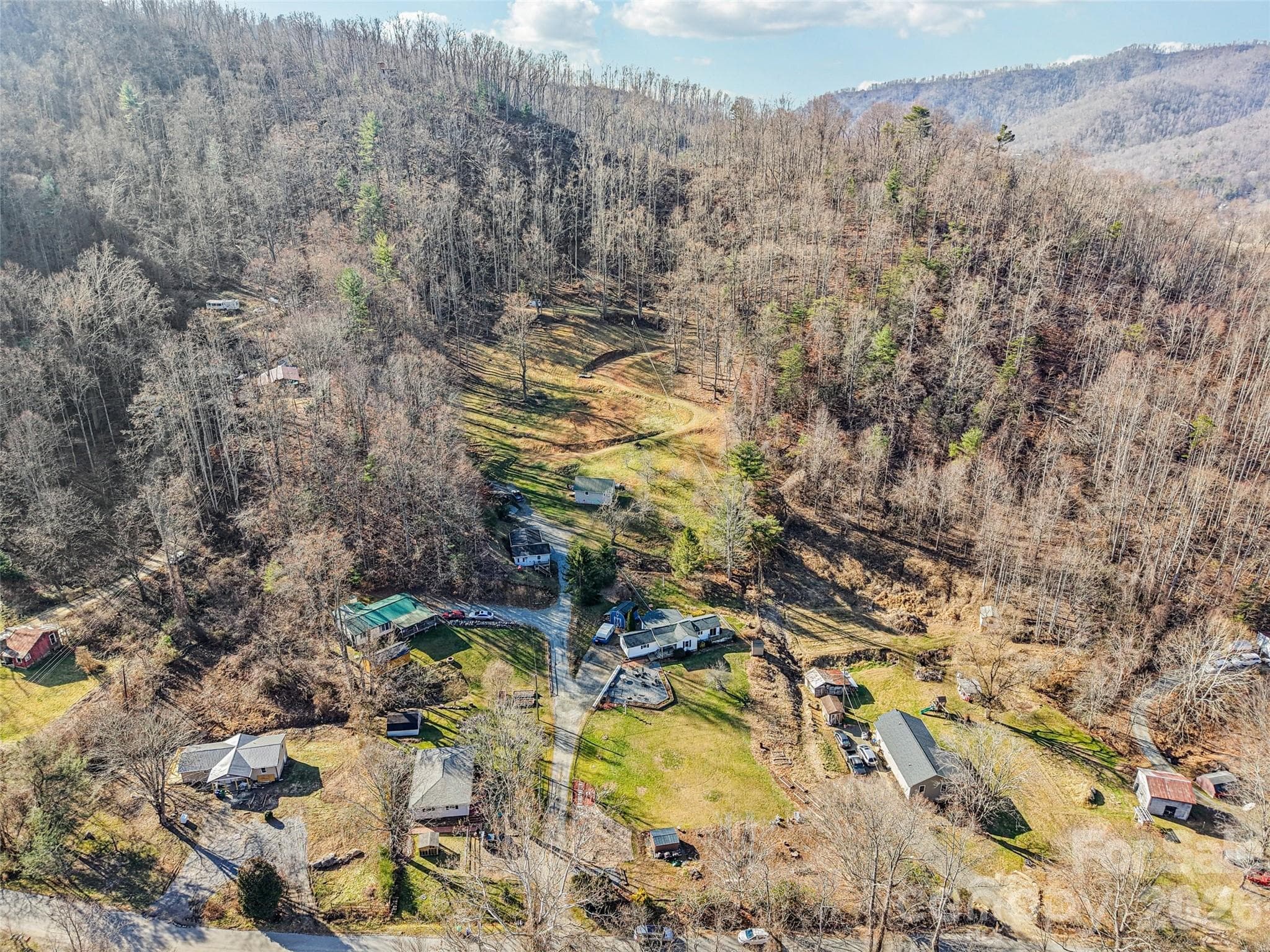 Aerial view of the property showing the surrounding neighborhood and mountain setting - 7 Landon Mountain Lane, Weaverville