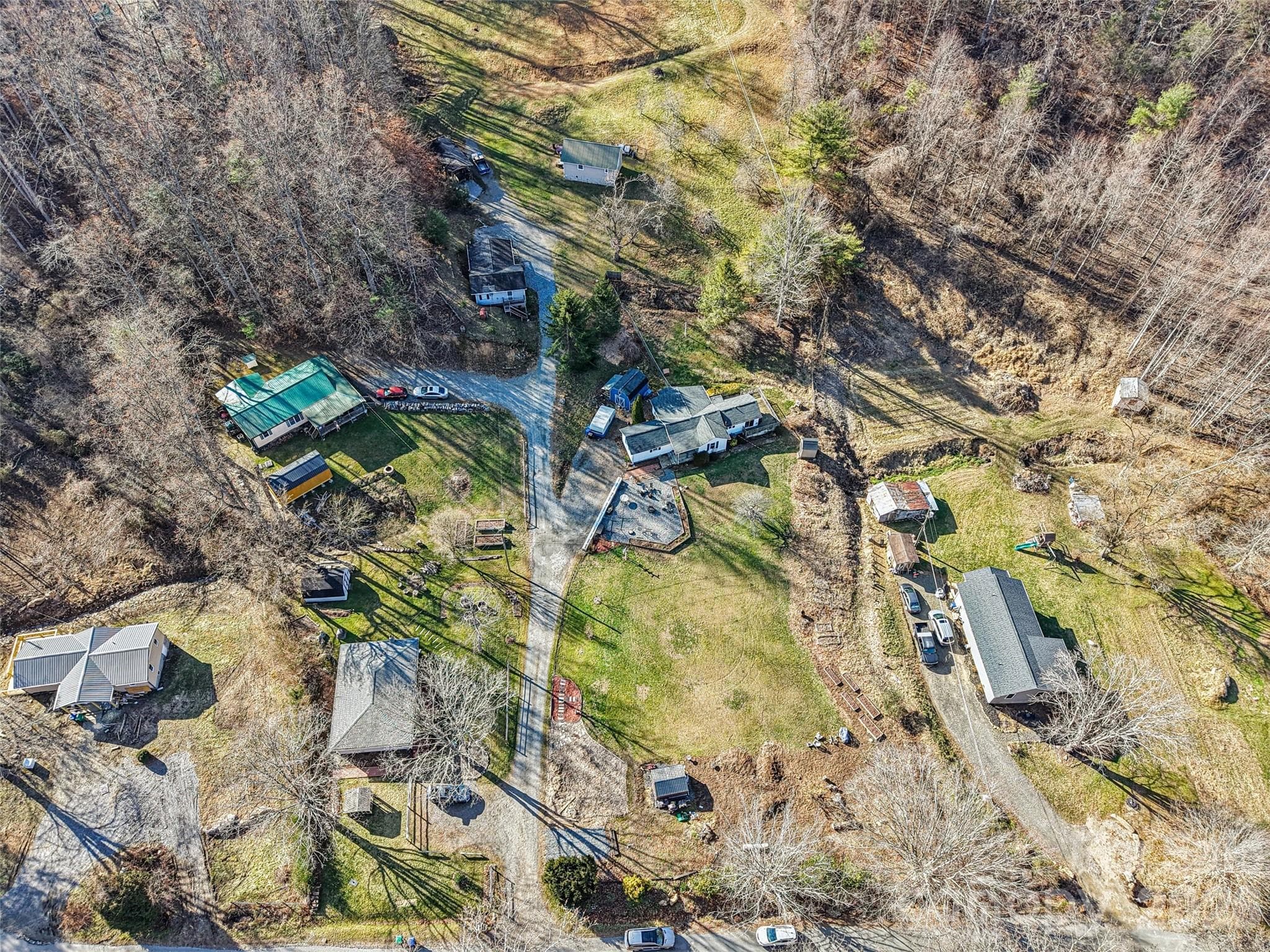 Aerial view of the property showing the surrounding neighborhood and mountain setting - 7 Landon Mountain Lane, Weaverville