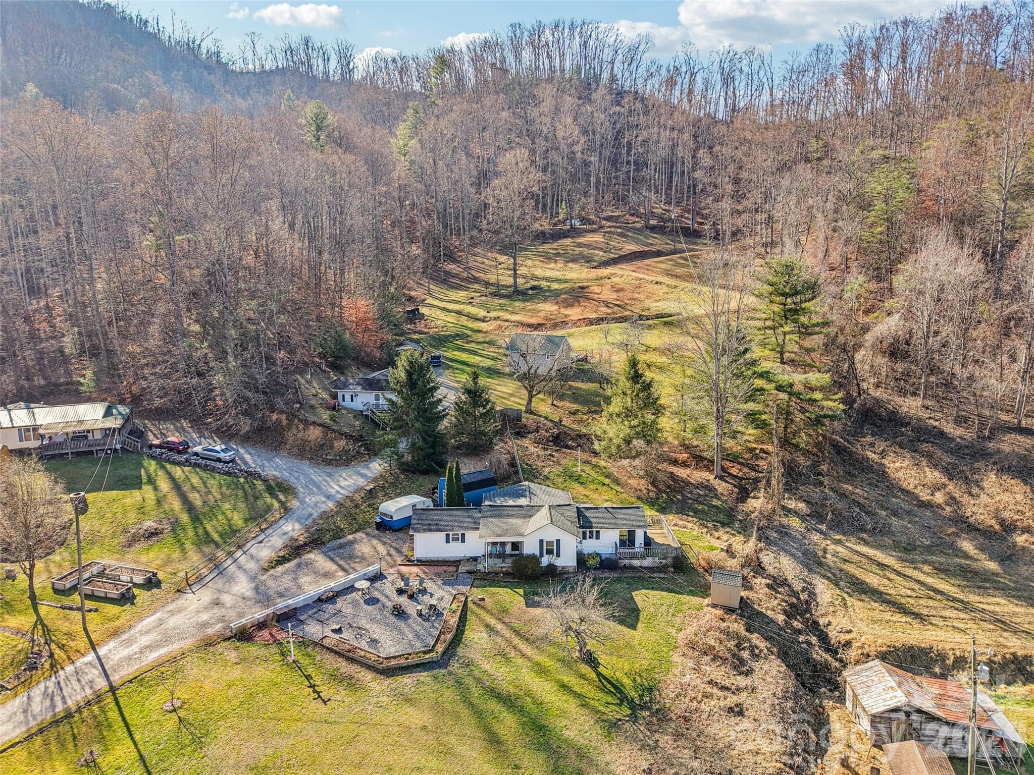 Aerial view of the property showing the surrounding neighborhood and mountain setting - 7 Landon Mountain Lane, Weaverville