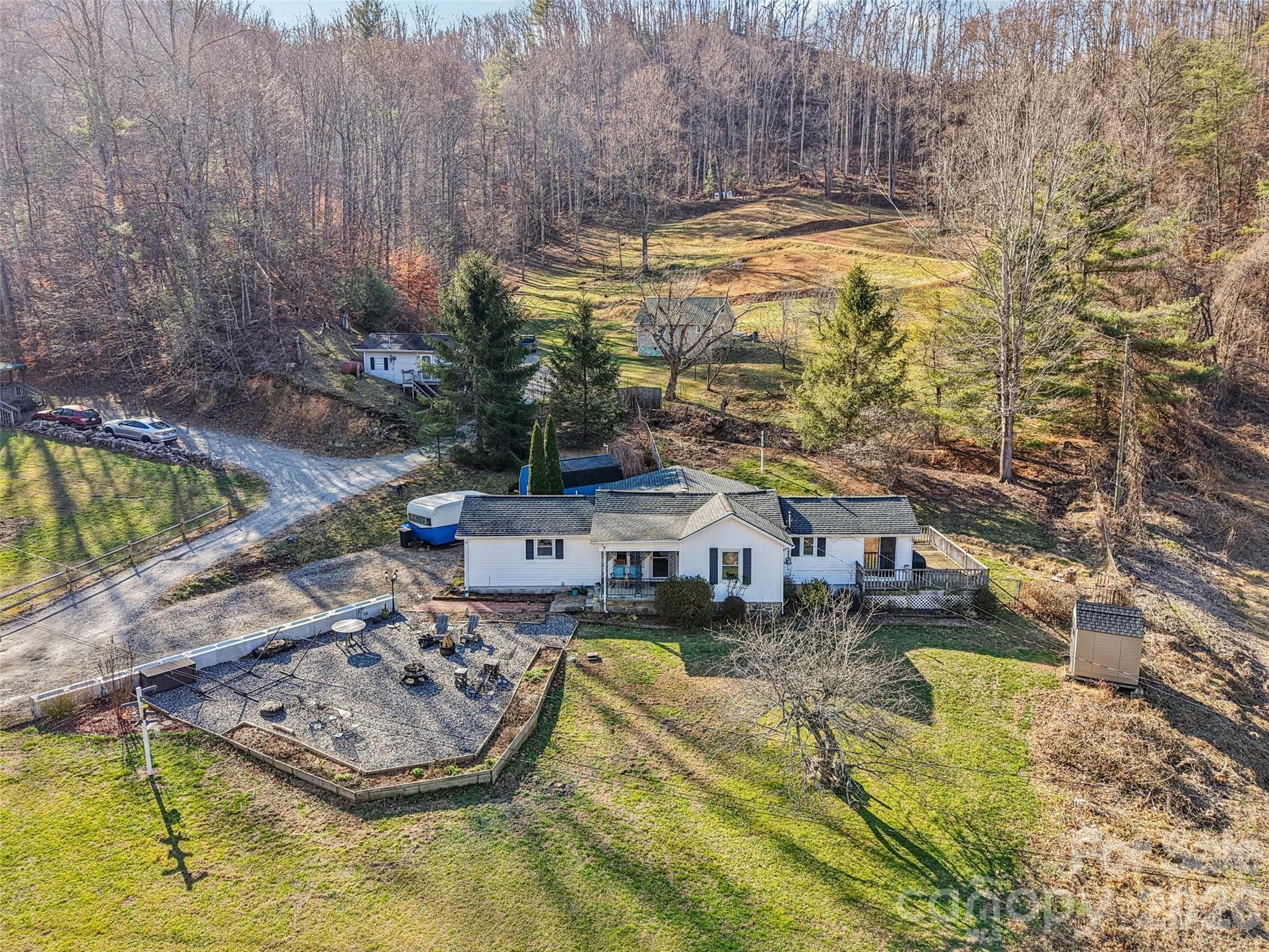 Aerial view of the property showing the surrounding neighborhood and mountain setting - 7 Landon Mountain Lane, Weaverville