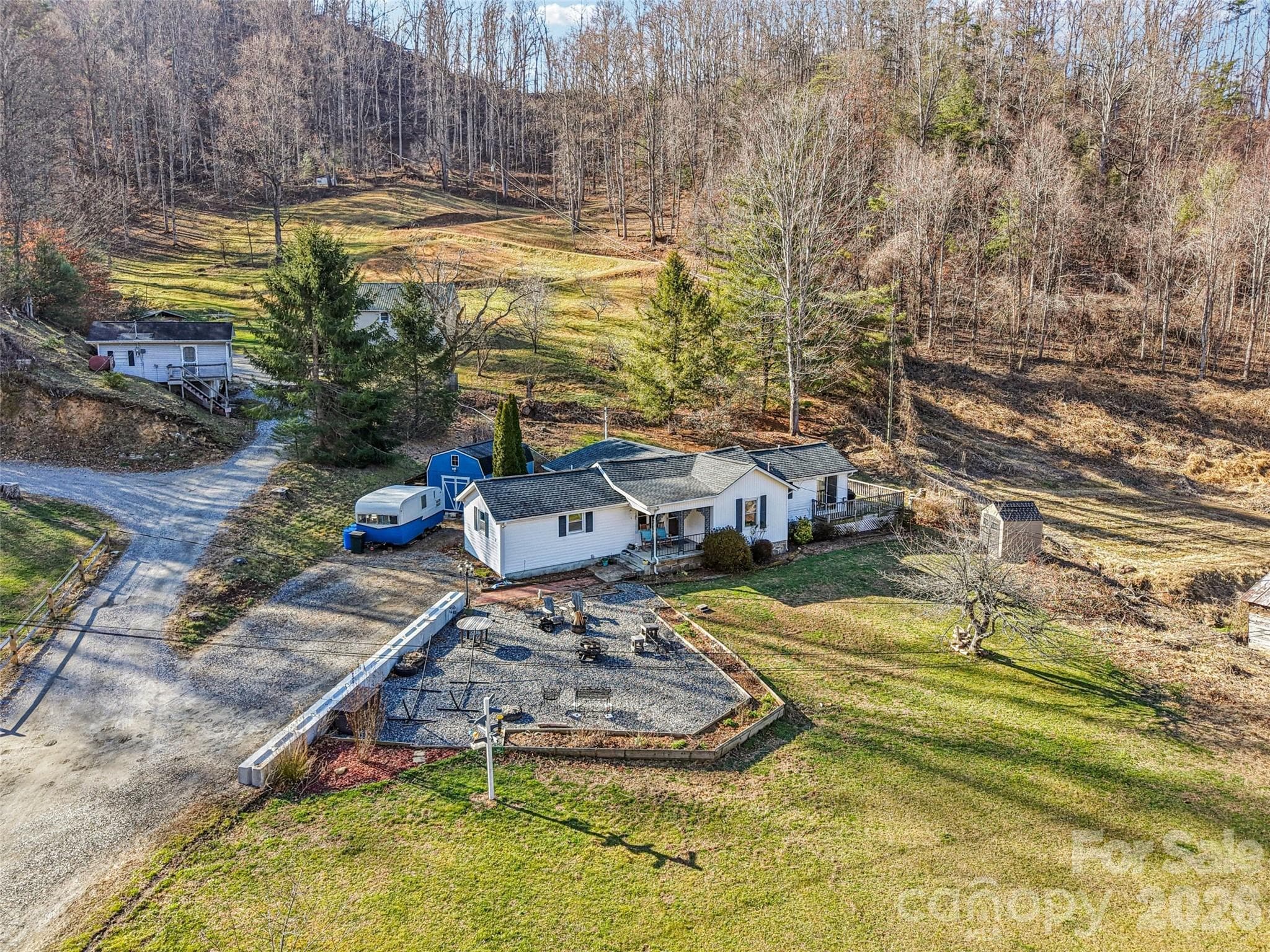 Aerial view of the property showing the surrounding neighborhood and mountain setting - 7 Landon Mountain Lane, Weaverville