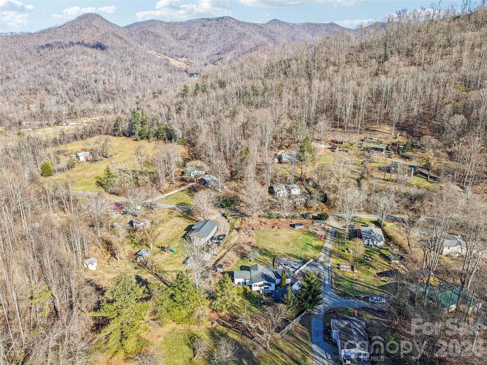 Aerial view of the property showing the surrounding neighborhood and mountain setting - 7 Landon Mountain Lane, Weaverville