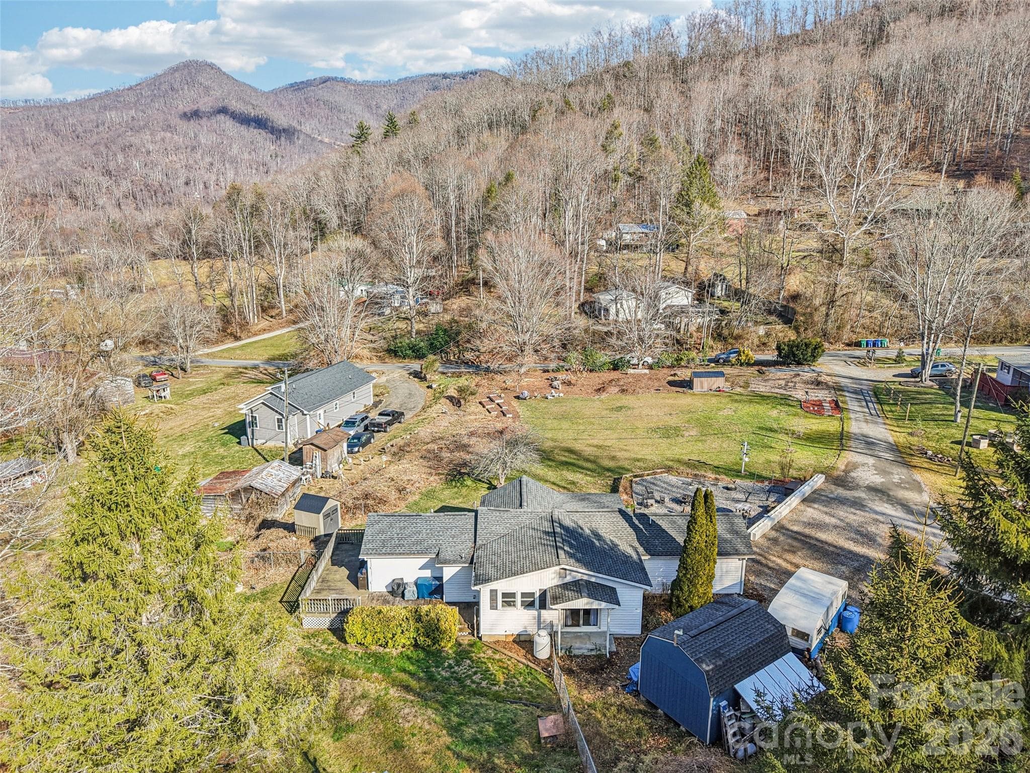 Aerial view of the property showing the surrounding neighborhood and mountain setting - 7 Landon Mountain Lane, Weaverville