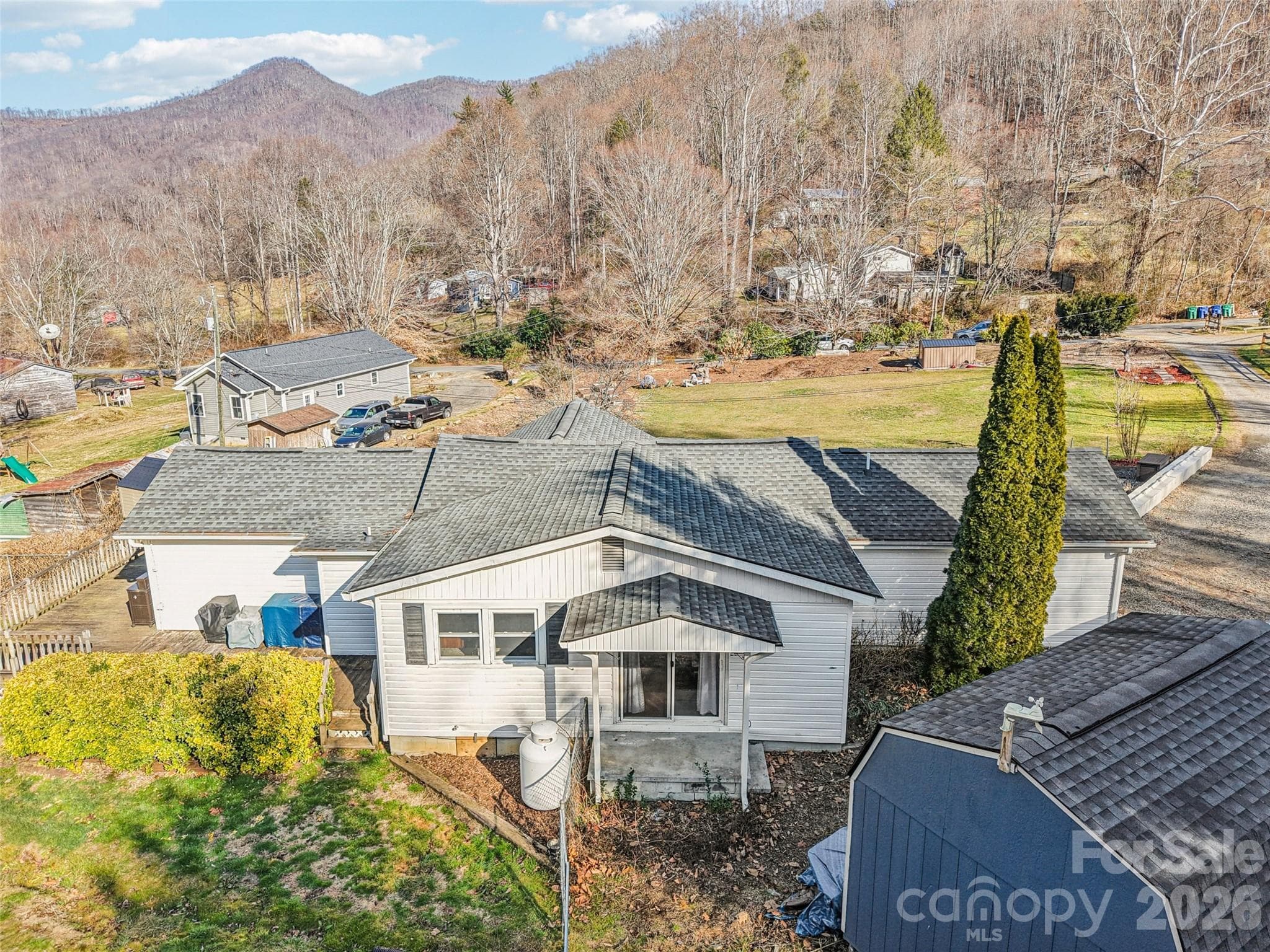 Aerial view of the property showing the surrounding neighborhood and mountain setting - 7 Landon Mountain Lane, Weaverville