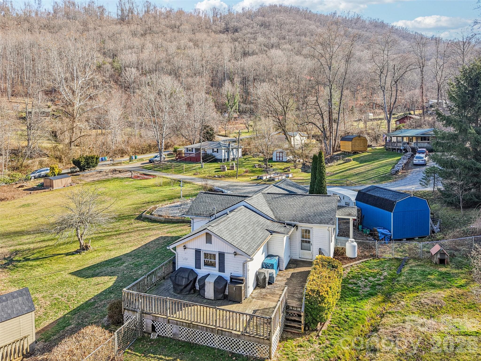 Aerial view of the property showing the surrounding neighborhood and mountain setting - 7 Landon Mountain Lane, Weaverville