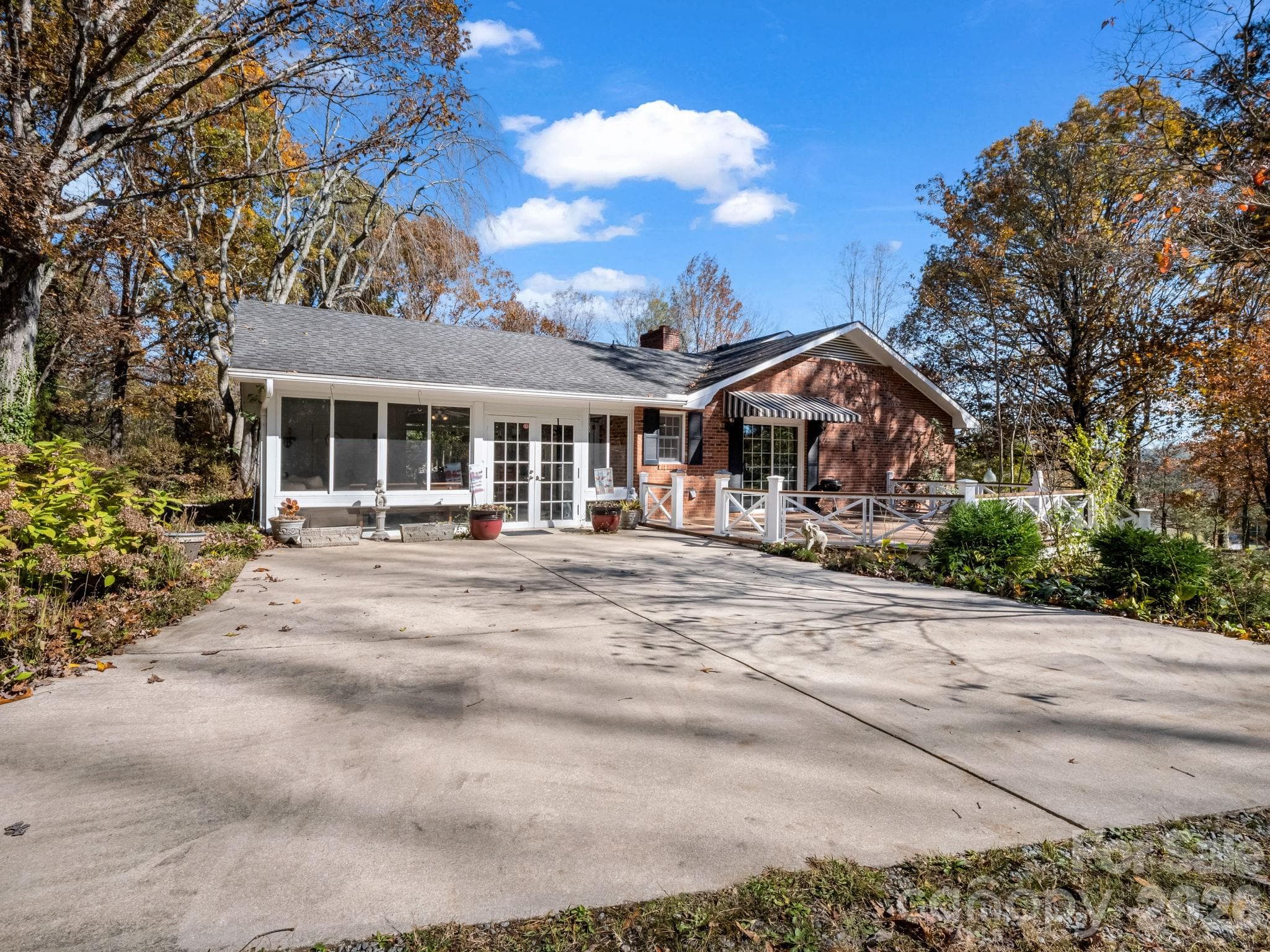 Upper parking area leading to sunroom and deck with view of the surrounding mountains - Hendersonville