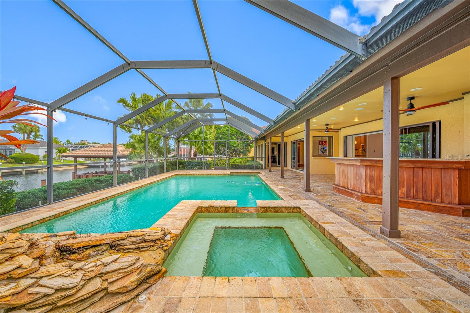 Pool and spa with waterfall and gazebo in background - 9807 COMPASS POINT WAY, TAMPA