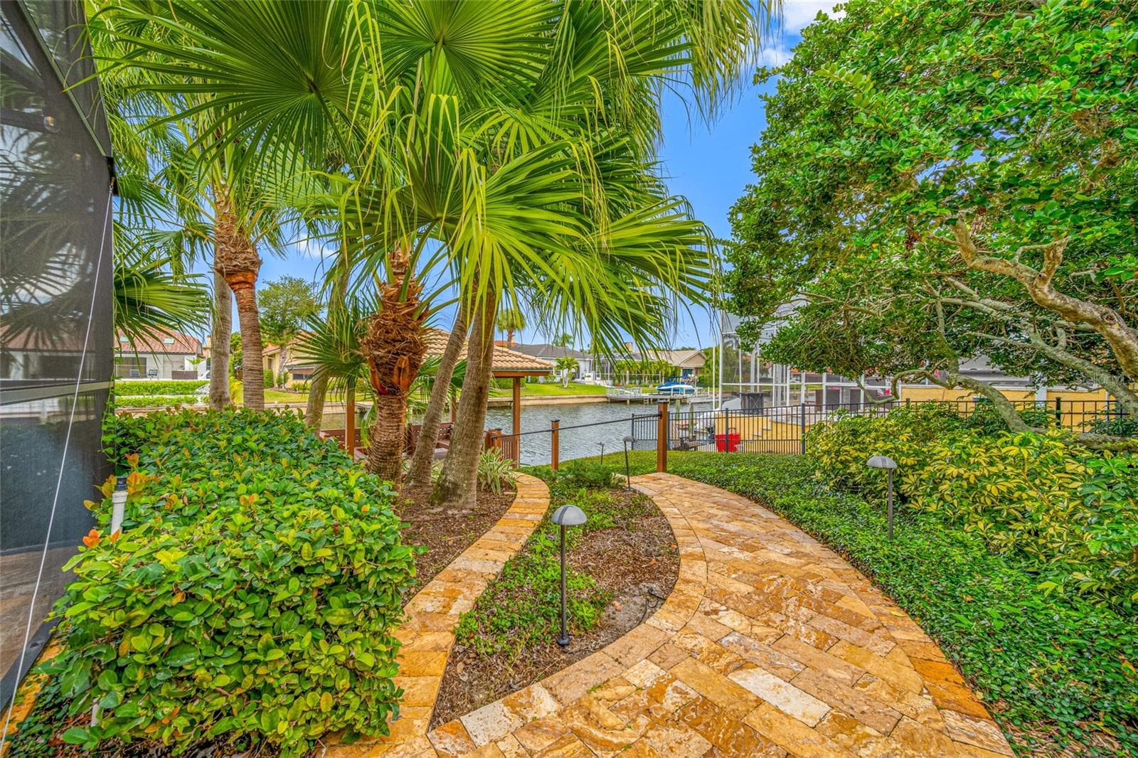 Travertine pathway to water and gazebo - 9807 COMPASS POINT WAY, TAMPA