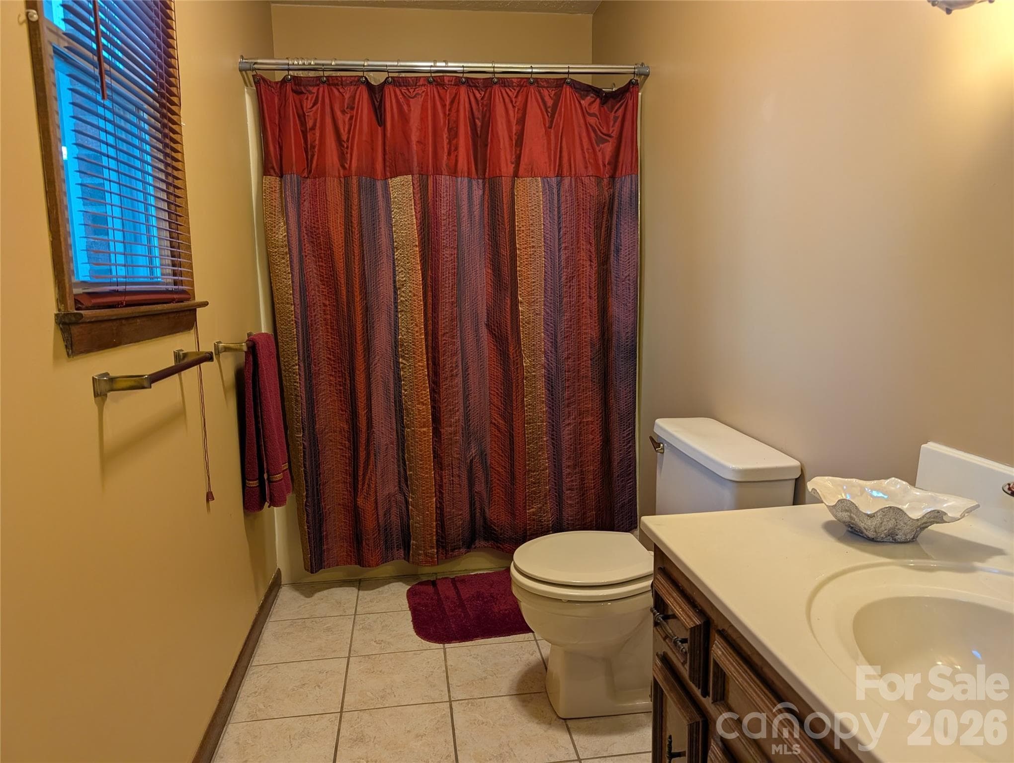 Primary Bath with tile floors,custom mirror and paint - 3065 Woodstream Drive, Valdese