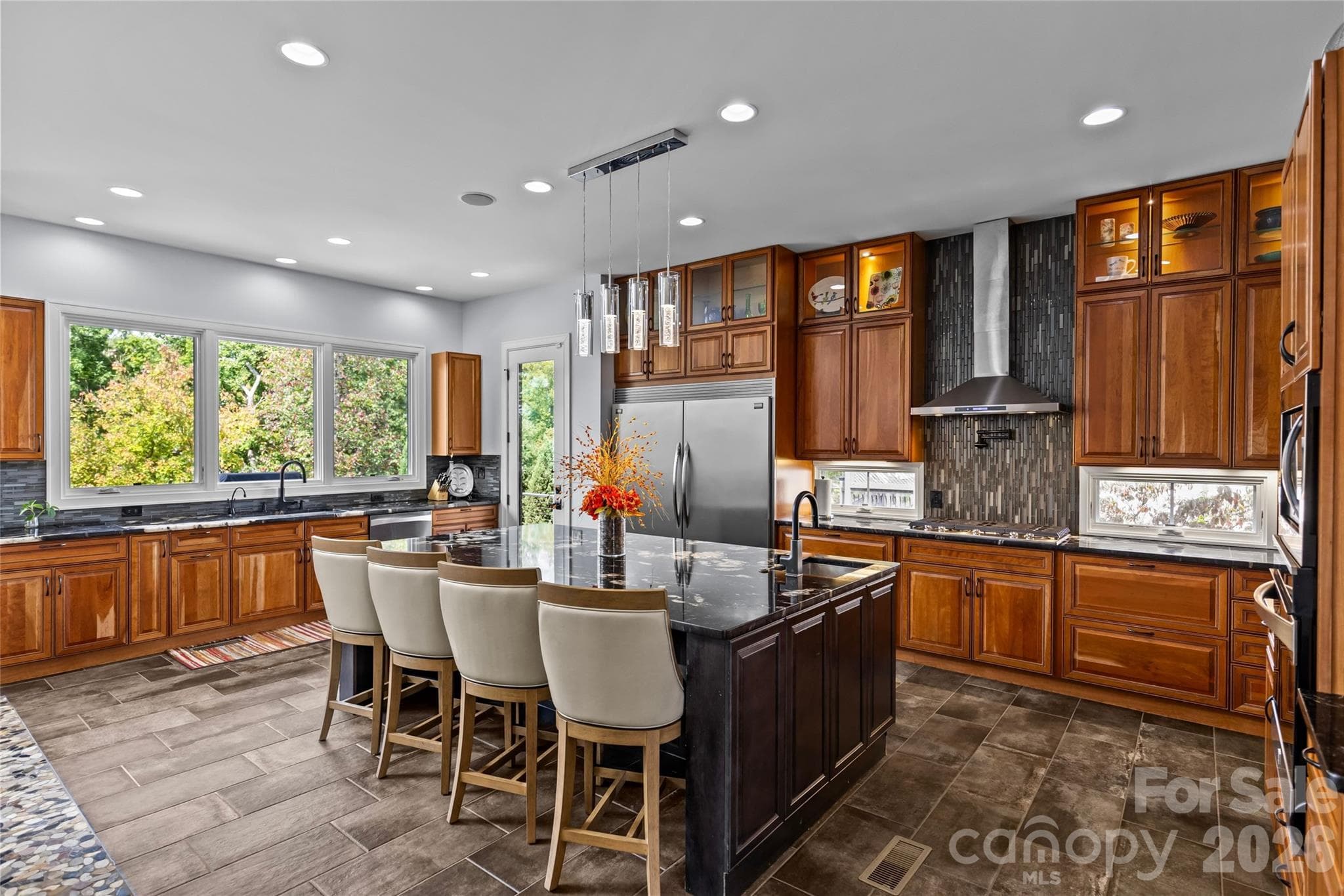 Stunning chef's kitchen has cherry & maple cabinets, granite countertops, oversized kitchen island, dual built-in stainless steel Frigidaire refrigerator & freezer, stainless steel appliances, prep sink in kitchen island with disposal, large butlers pantry with additional sink & dishwasher, & bar with ice maker. - 6032 Headlands Court, Belmont