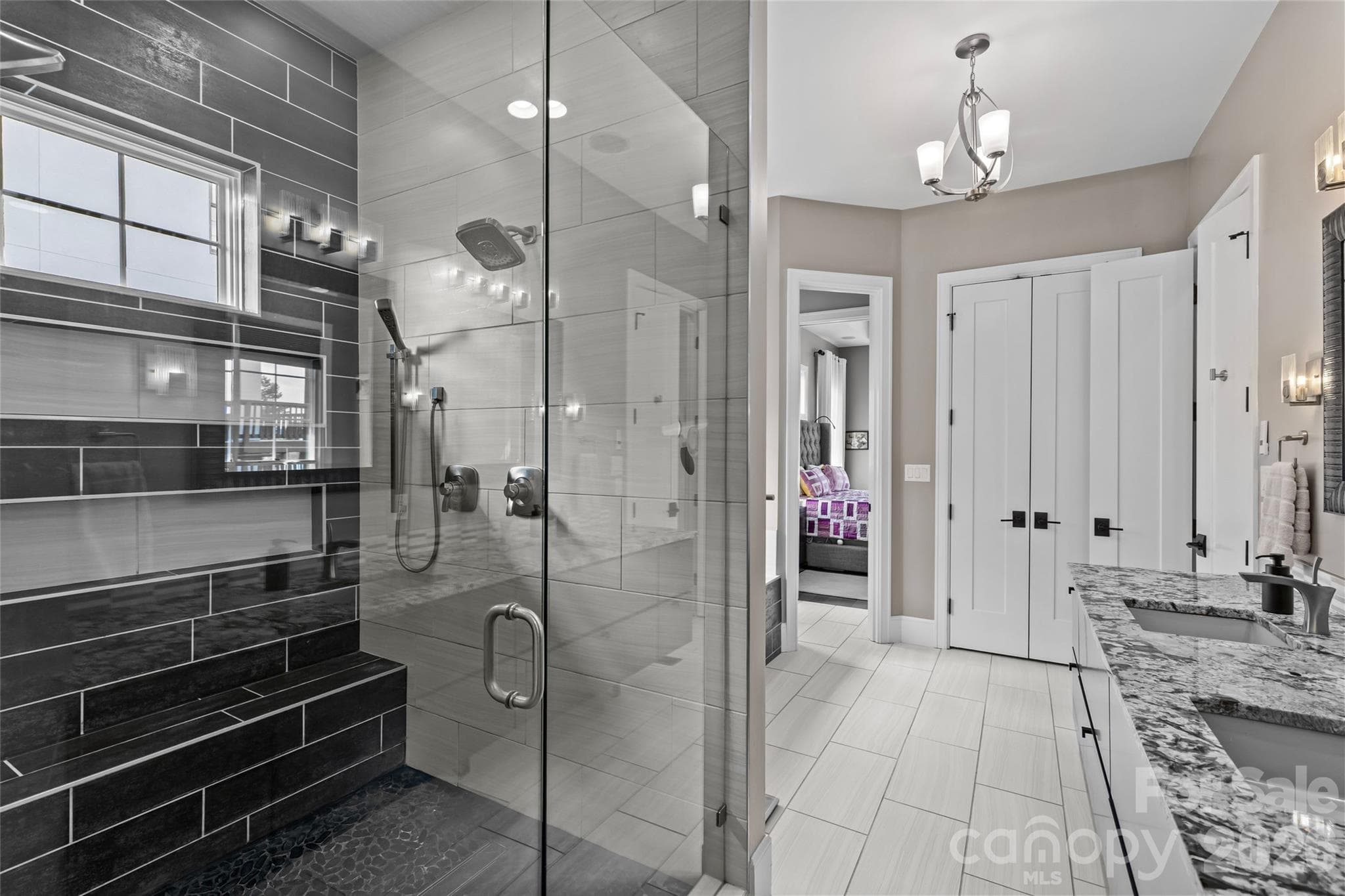 Primary suite has stunning lake views, gas fireplace, sitting area/office, double vanity, shower, bathtub, water closet & walk-in closet with access to the laundry room. - 6032 Headlands Court, Belmont