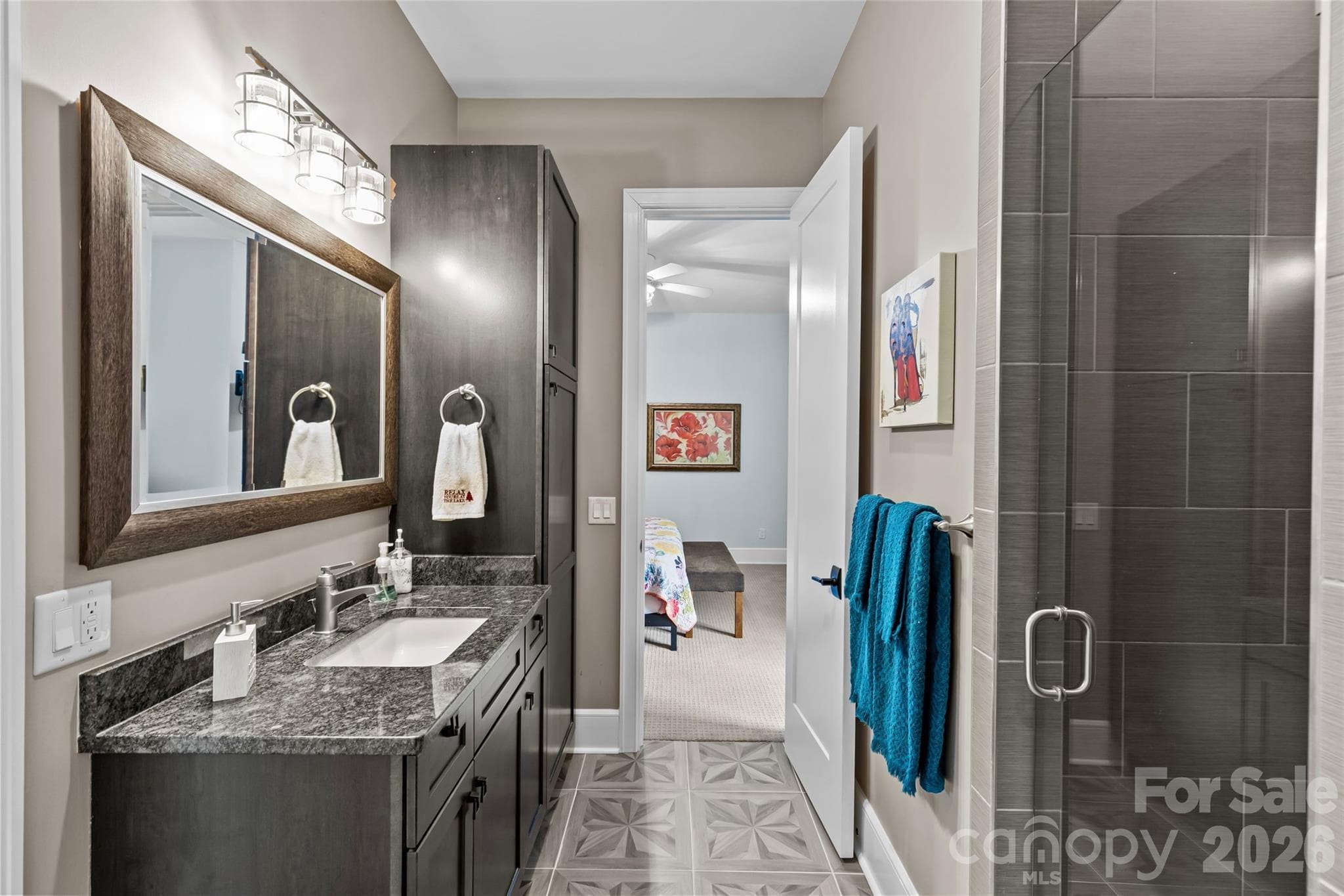 Lower level features an oversized family room with gas fireplace, 3 bedrooms, 2 full bathrooms, incredible walk in storage & sliding door access to the screened in porch. - 6032 Headlands Court, Belmont