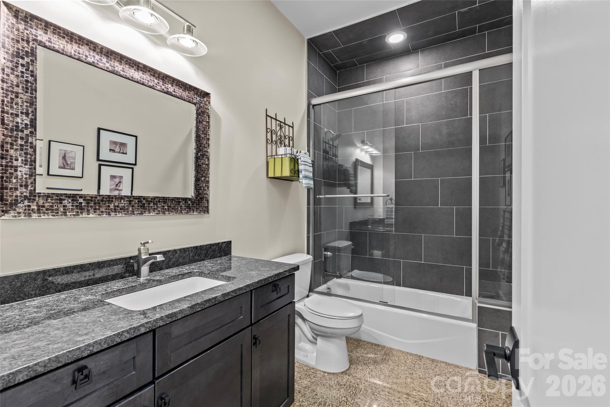 Lower level features an oversized family room with gas fireplace, 3 bedrooms, 2 full bathrooms, incredible walk in storage & sliding door access to the screened in porch. - 6032 Headlands Court, Belmont