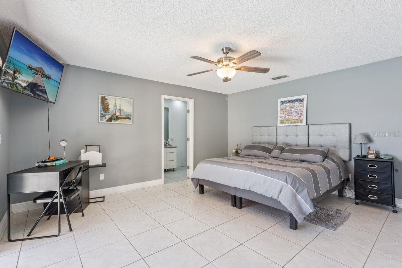 Primary bedroom with view of pool - 8215 ROLLA CT, ORLANDO