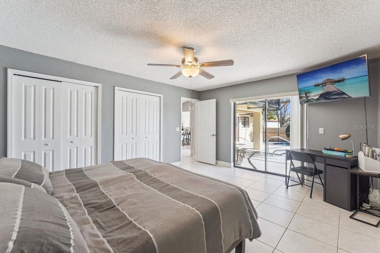 Primary bedroom with view of pool - 8215 ROLLA CT, ORLANDO