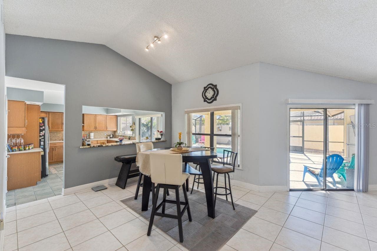 View of dinette in great room with access to pool and kitchen - 8215 ROLLA CT, ORLANDO