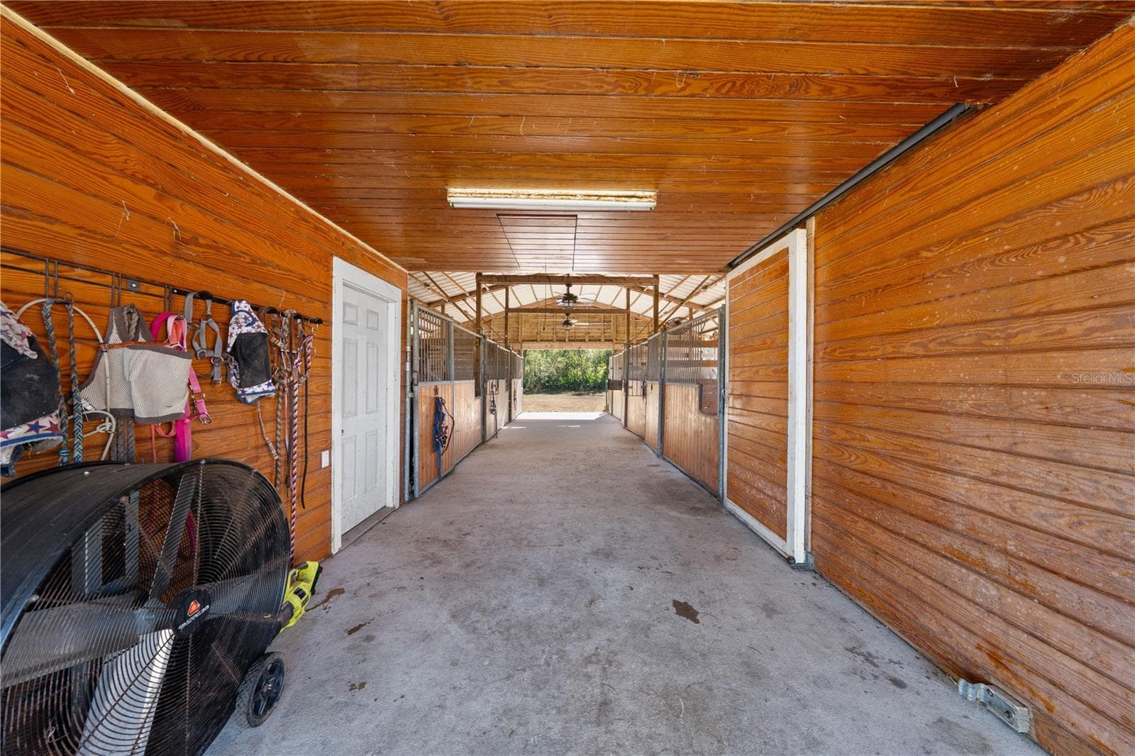 Center aisle of horse barn - 3255 TUCKER AVE, ST CLOUD