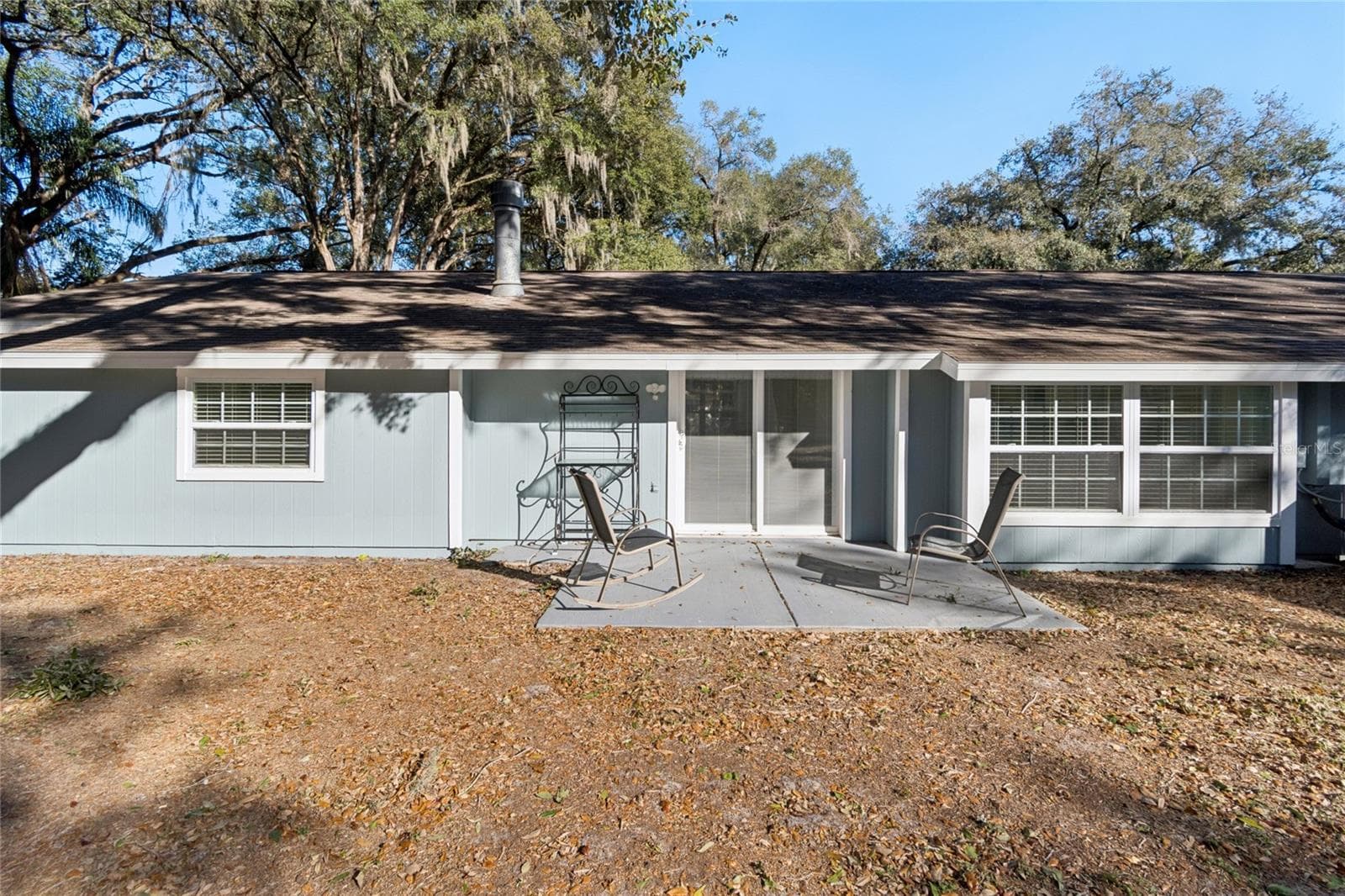 Back of Main House with Sliding Galss Doors to Patio - 9628 DAVIS RD, TAMPA