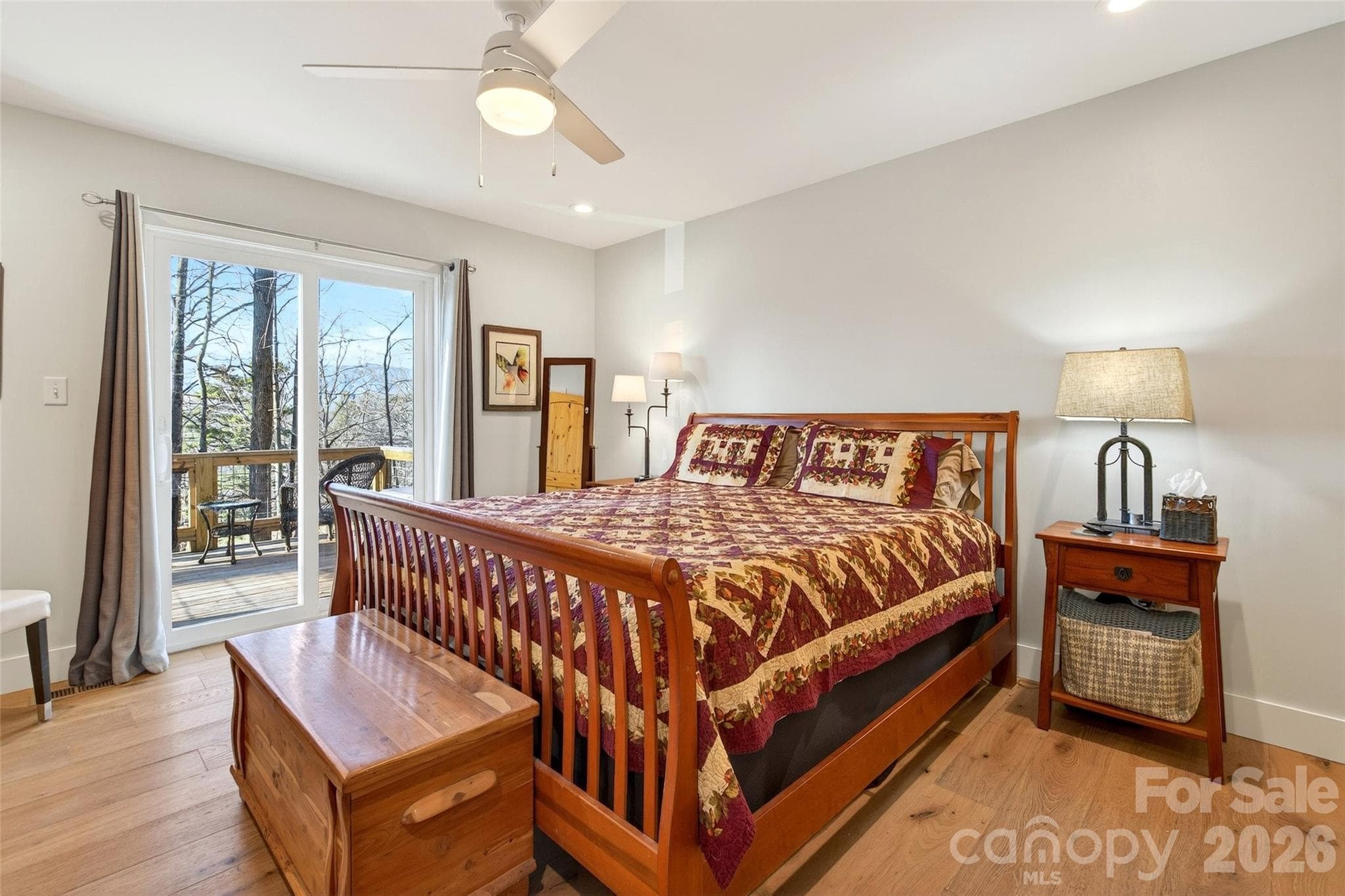 Primary bedroom on the main floor with large closet space and deck. - 1413 Golf Course Road, Old Fort