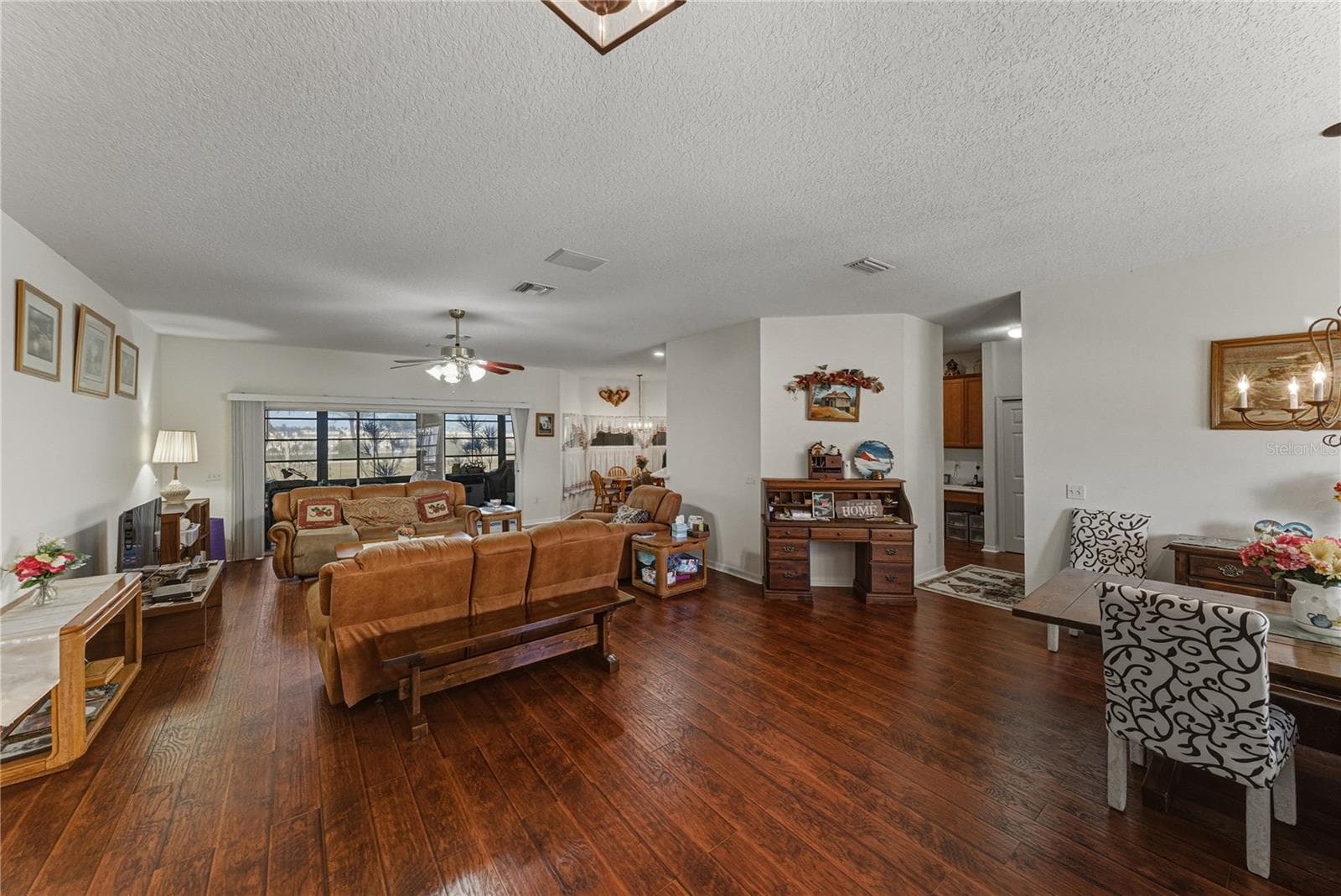 This view from the foyer shows the flexibilty of this space. The triple slider in the background opens to the covered and enclosed lanai. - 4360 ASHTON CLUB DR, LAKE WALES