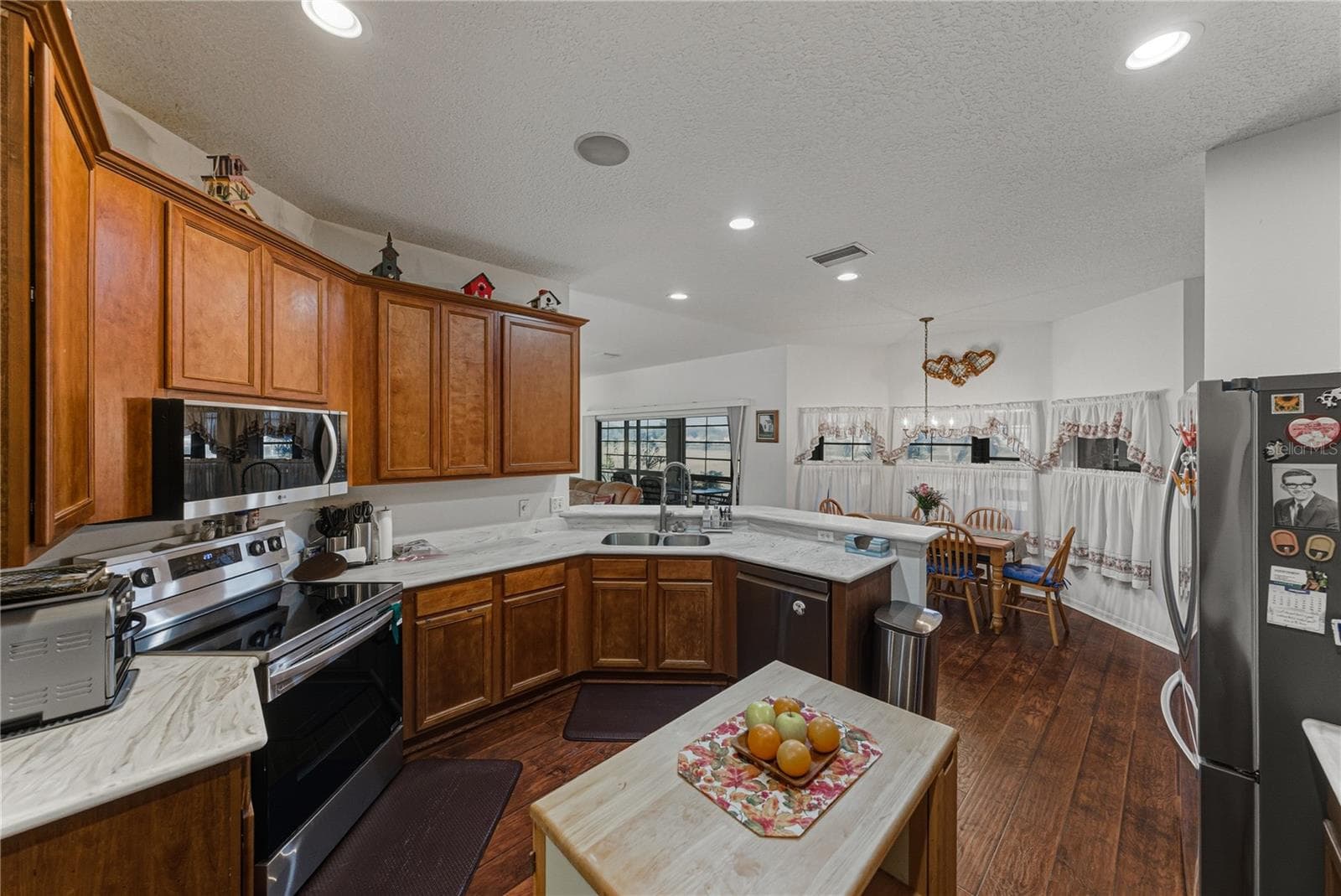 The kitchen has ample cabinetry and Corian countertops. - 4360 ASHTON CLUB DR, LAKE WALES