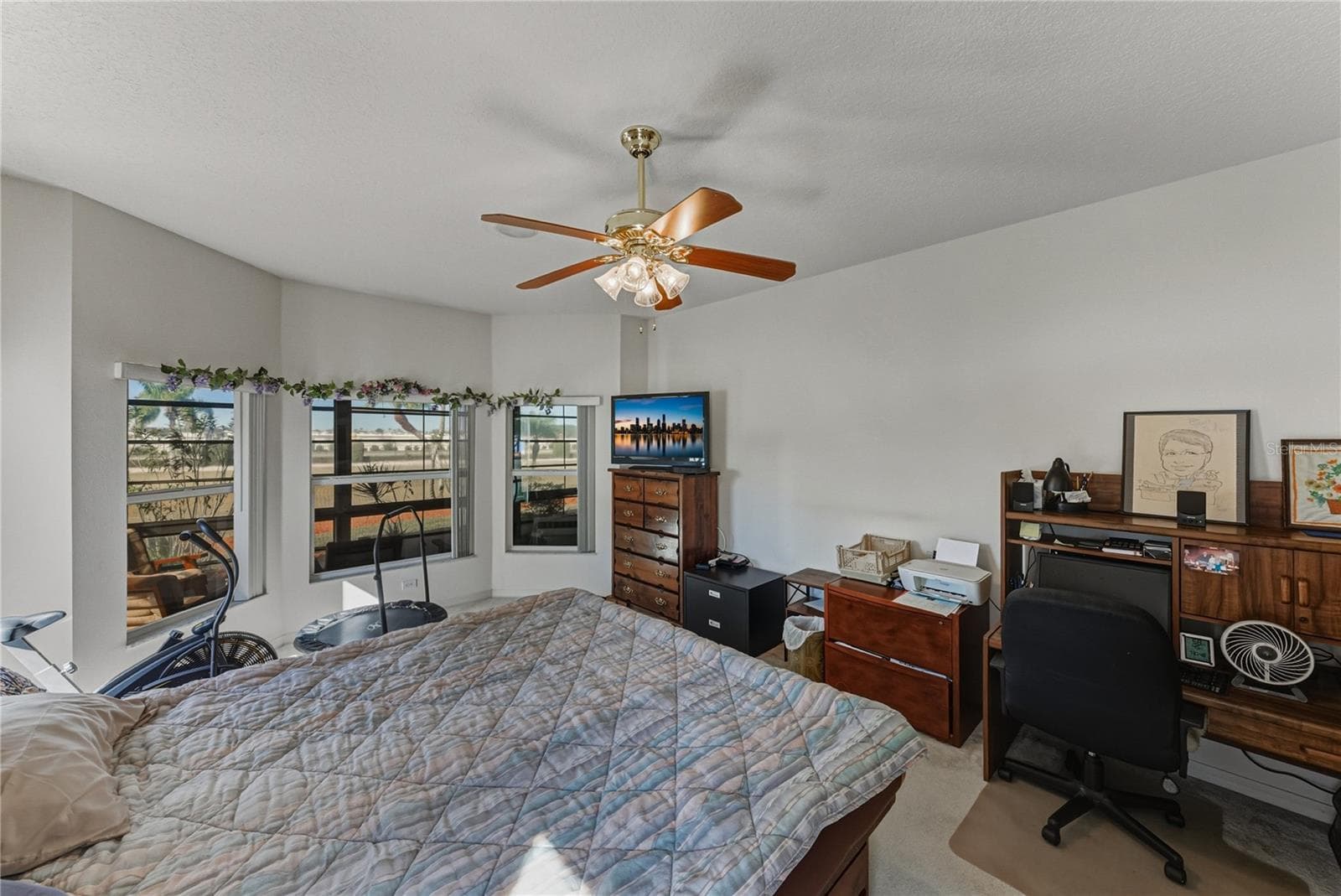 The primary bedroom in the "master" suite has a bay window area. - 4360 ASHTON CLUB DR, LAKE WALES