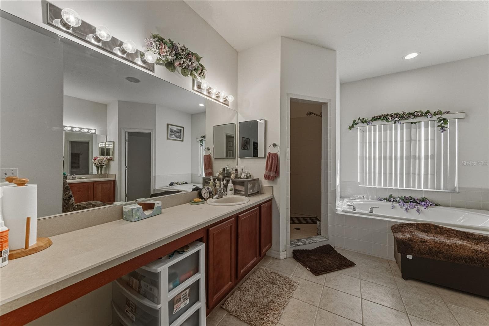 The primary bath has 2 vanities, a garden tub, a stall shower and a privacy toilet room. - 4360 ASHTON CLUB DR, LAKE WALES