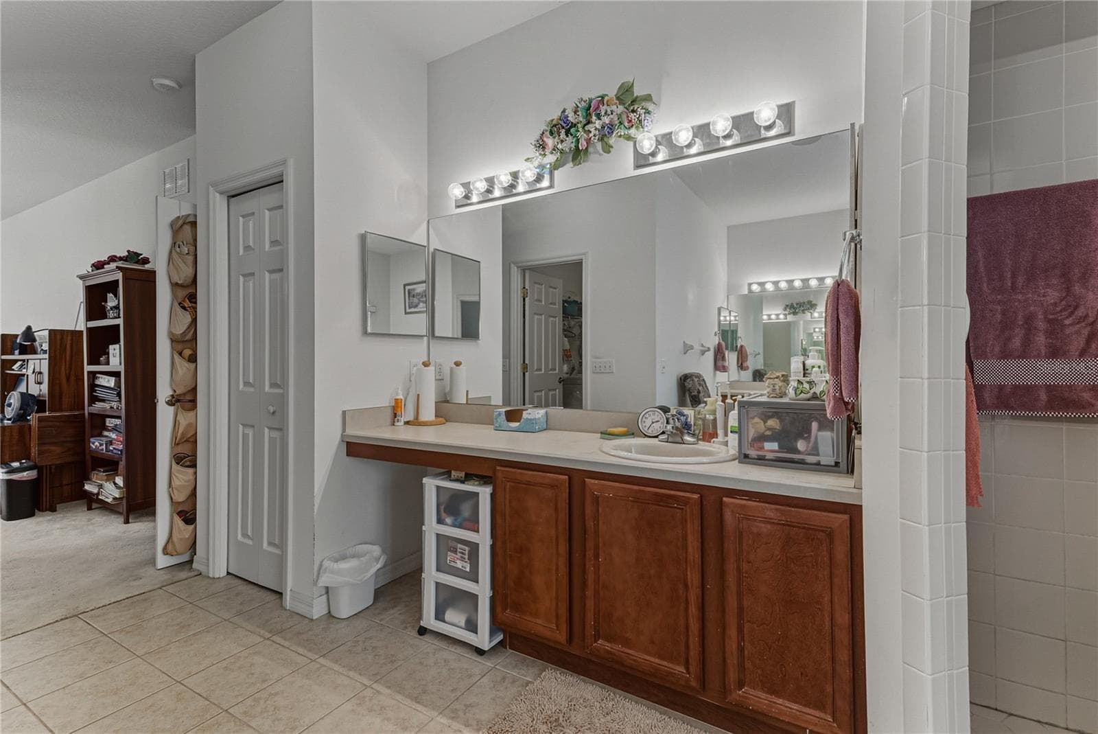 The primary bath has a linen closet and a makeup area. - 4360 ASHTON CLUB DR, LAKE WALES