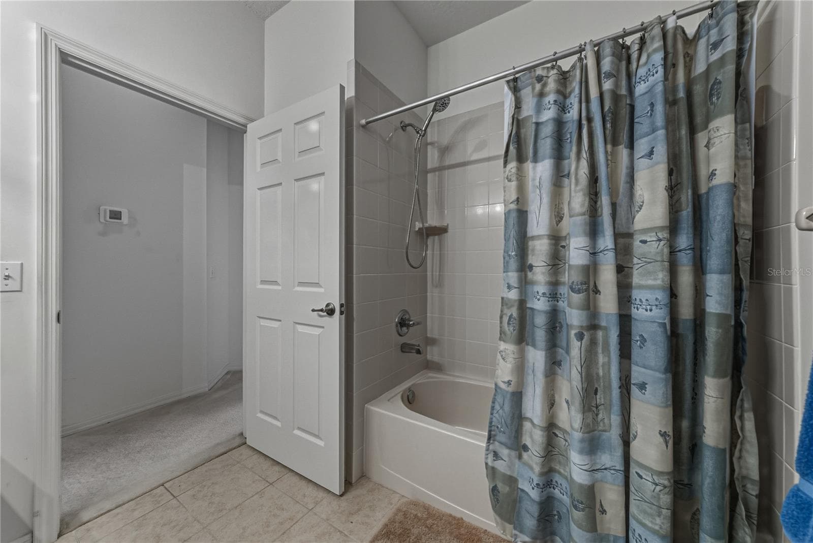 The guest bath has a ceramic tile surround in the combination tub and shower. - 4360 ASHTON CLUB DR, LAKE WALES