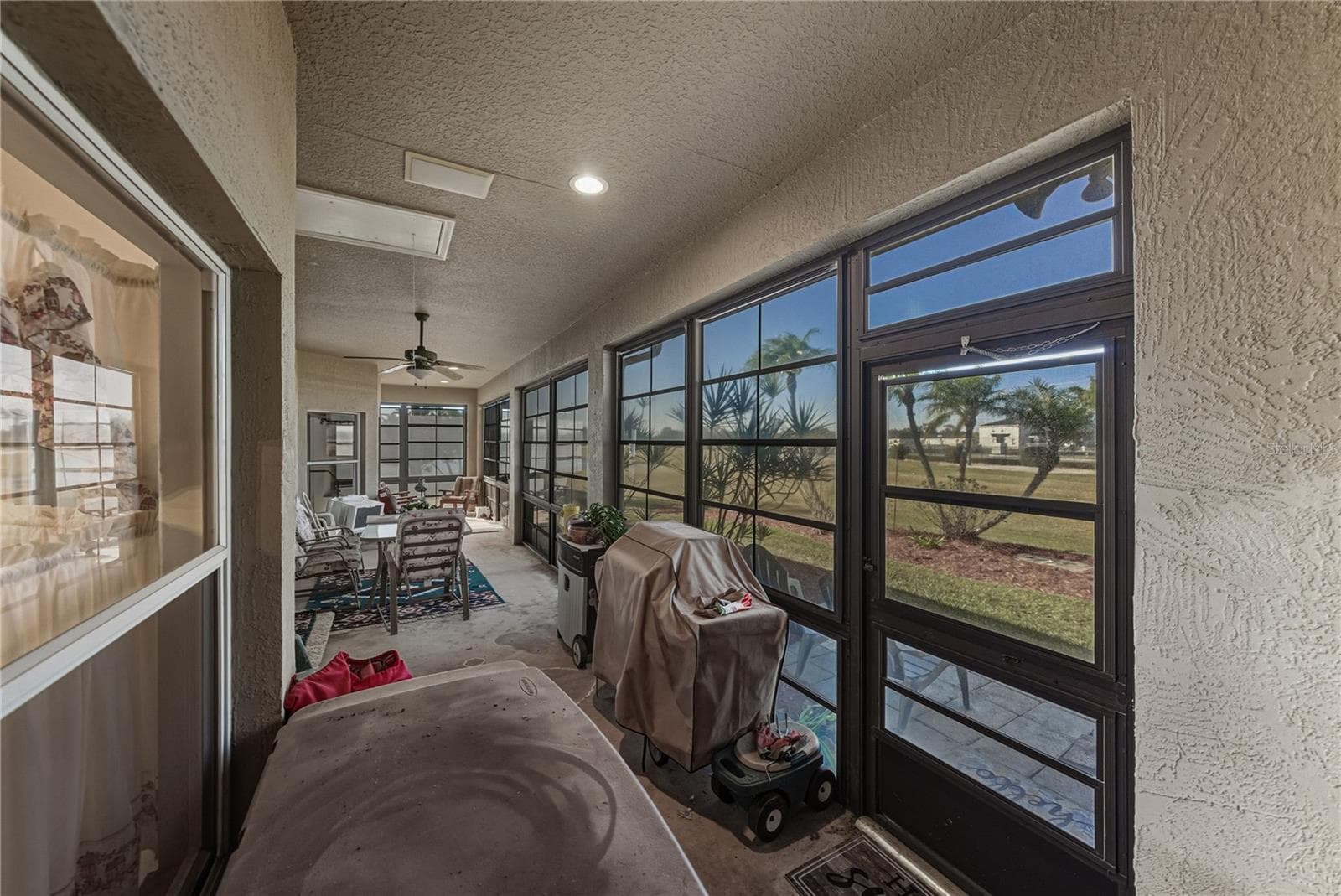 The covered and enclosed lanai is 43 feet long and dominates the rear of this home. - 4360 ASHTON CLUB DR, LAKE WALES