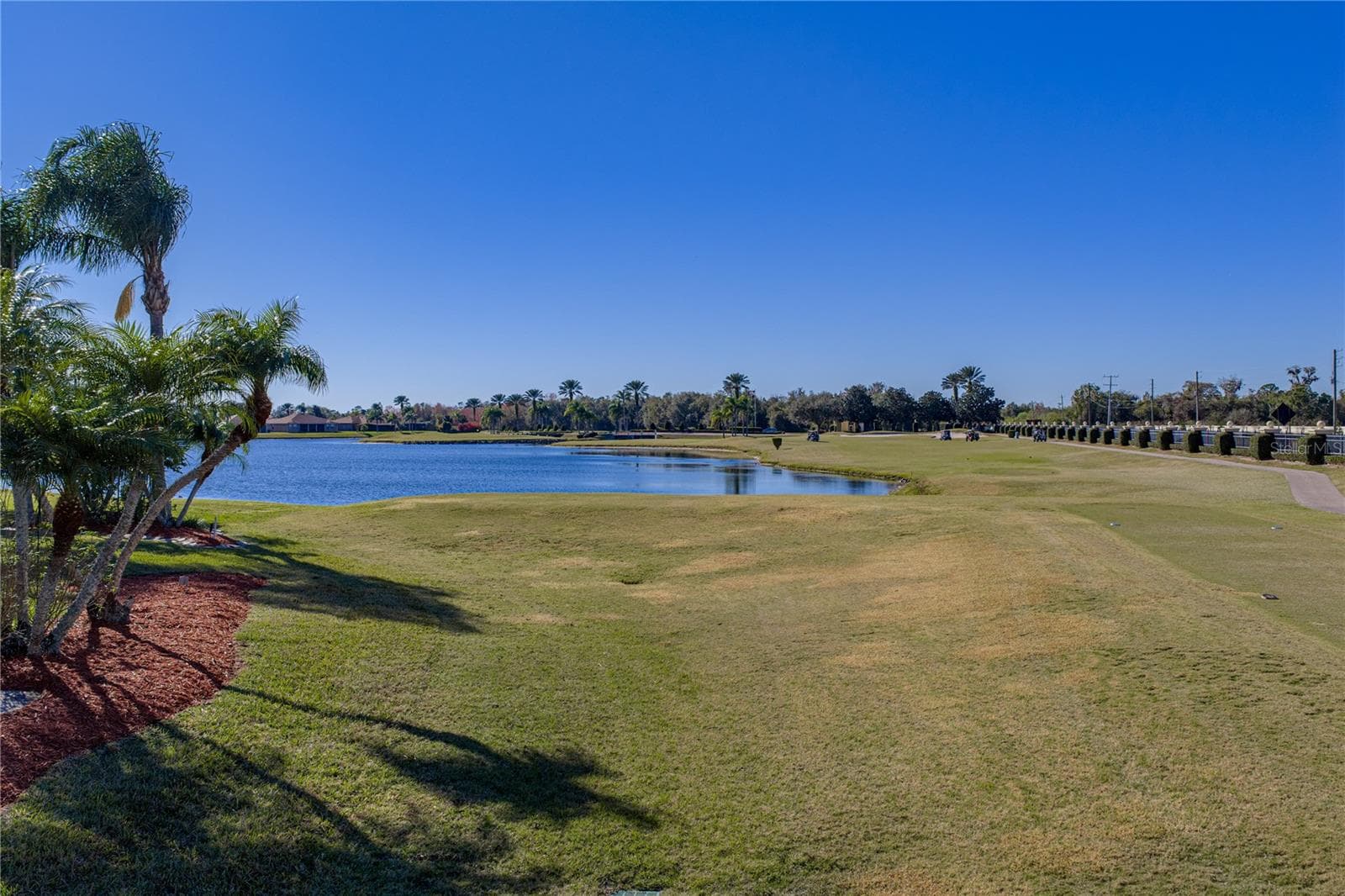 This home also abuts the tee box for Lake Ashton's East Course's 11th hole, a dog leg par 4 with an island green. - 4360 ASHTON CLUB DR, LAKE WALES