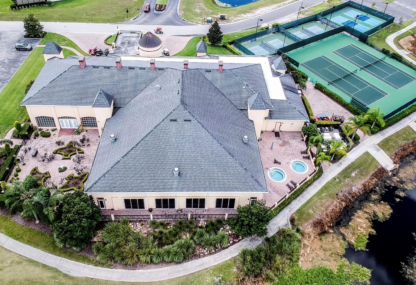 The rear of the Health and Fitness Center is dominated by the indoor pool. The spa patio is on the right and the rose garden is on the left. - 4360 ASHTON CLUB DR, LAKE WALES