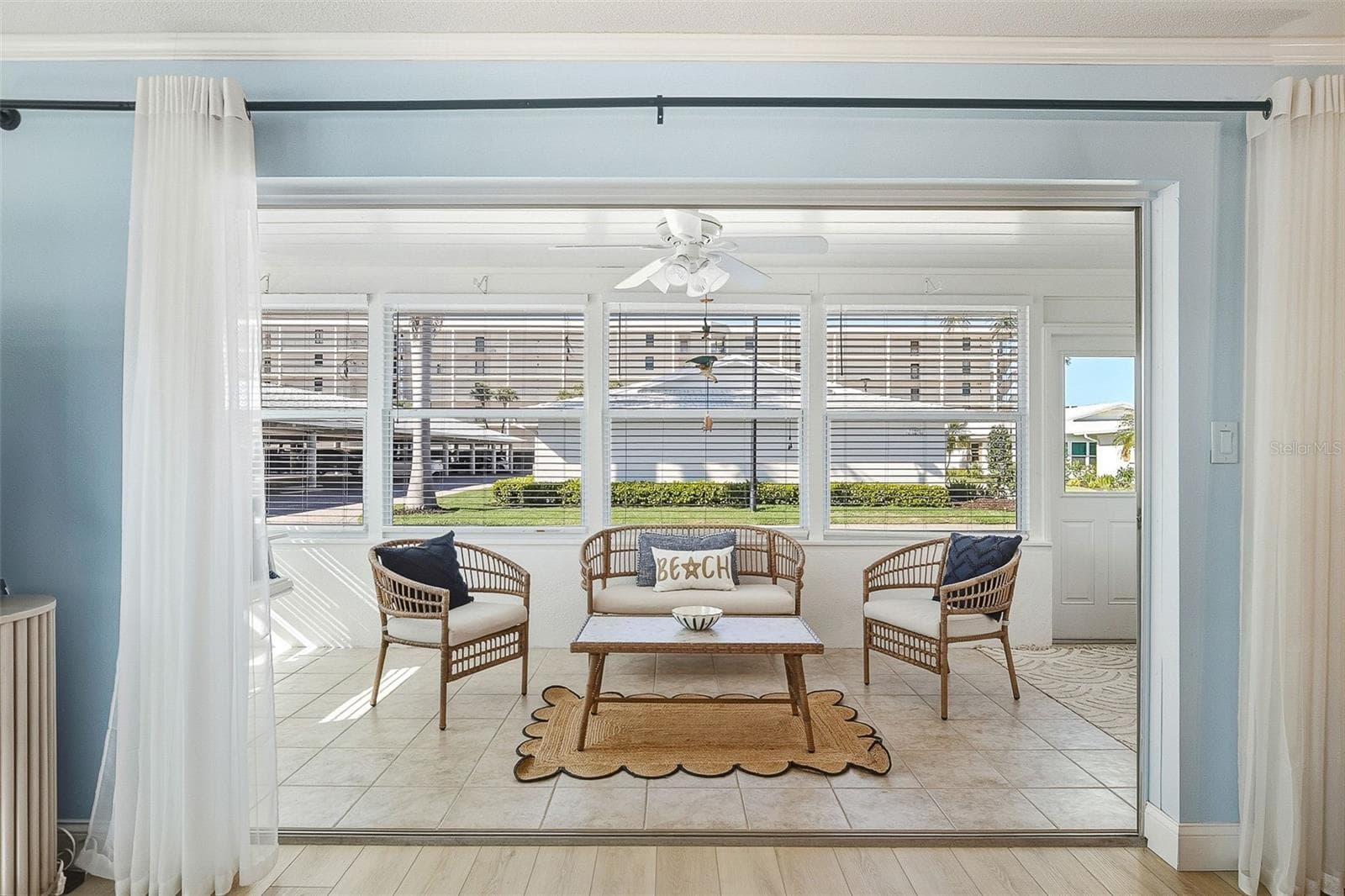 Enclosed Florida room provides extra living space with easy-care tile flooring and plentiful natural light. - 6300 MIDNIGHT PASS RD #21, SARASOTA
