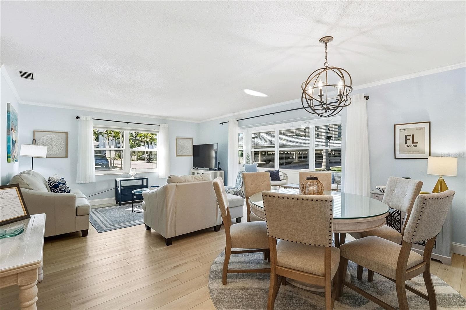 Open plan dining/living area with a coastal feel. - 6300 MIDNIGHT PASS RD #21, SARASOTA