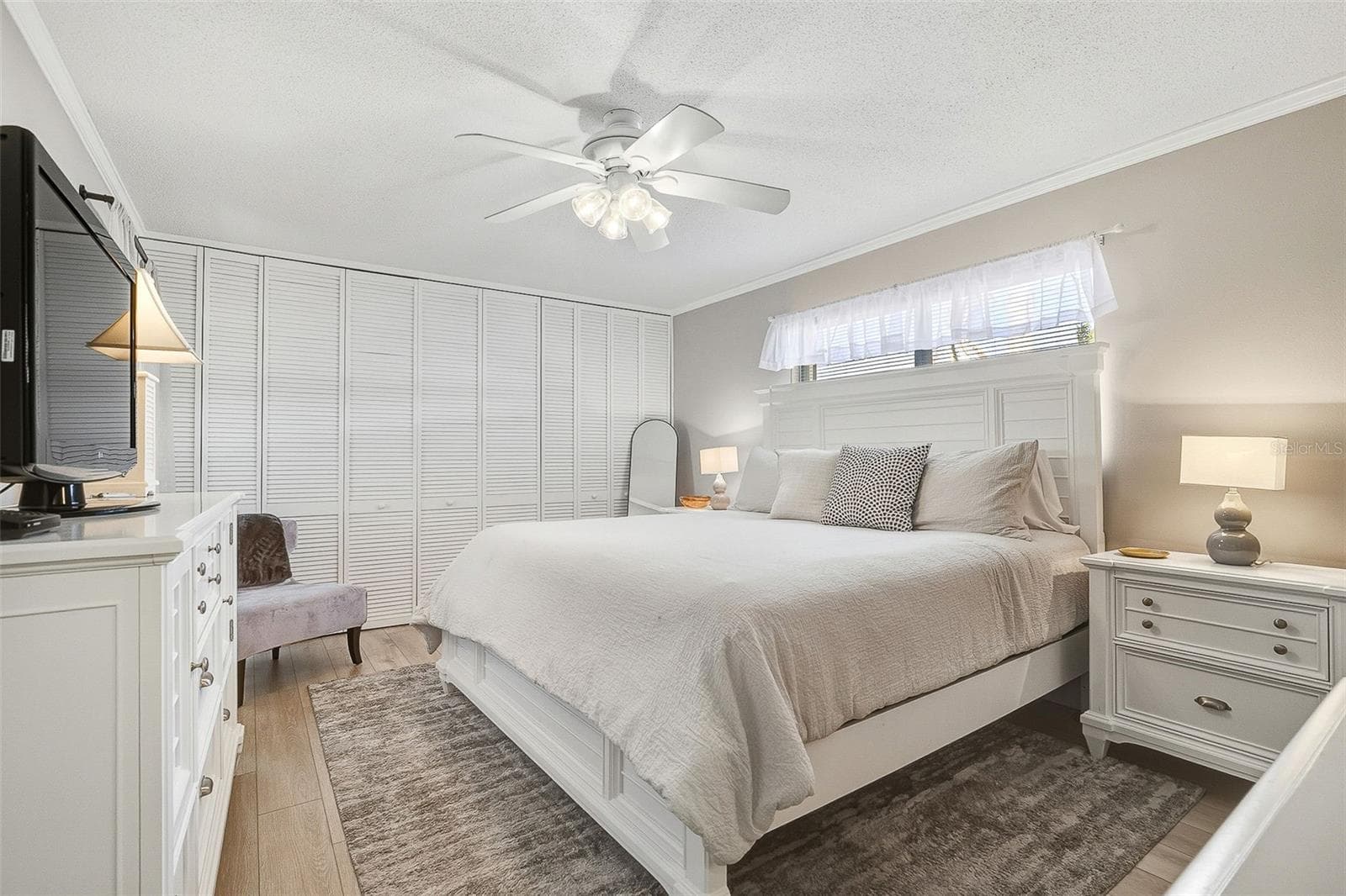 The primary bedroom offers a large closet and private ensuite bath. - 6300 MIDNIGHT PASS RD #21, SARASOTA