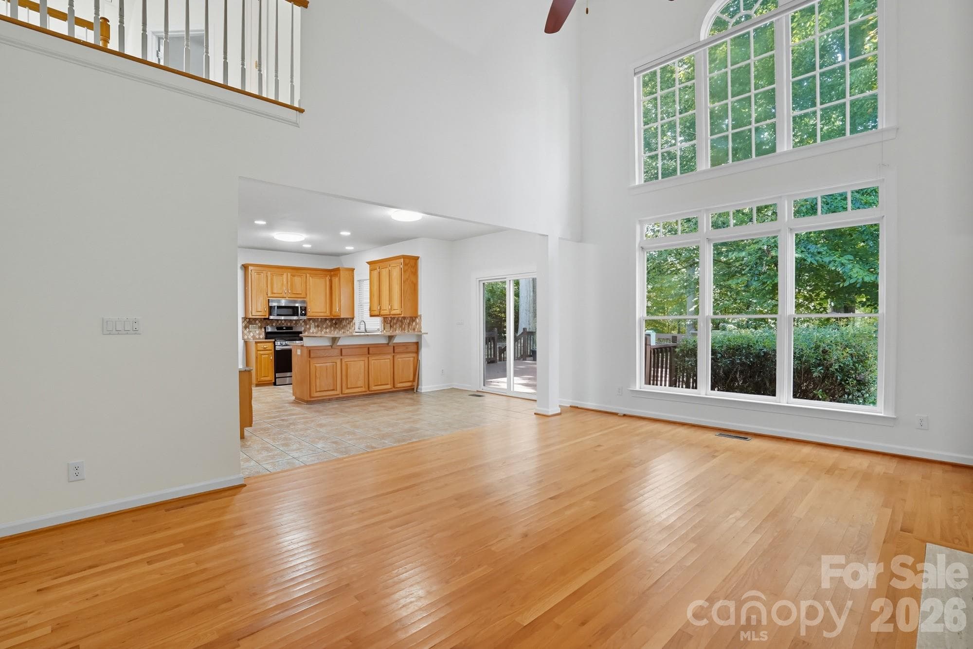 Living room with beautiful floor to ceiling windows! - 8016 Painted Pony Court, Charlotte