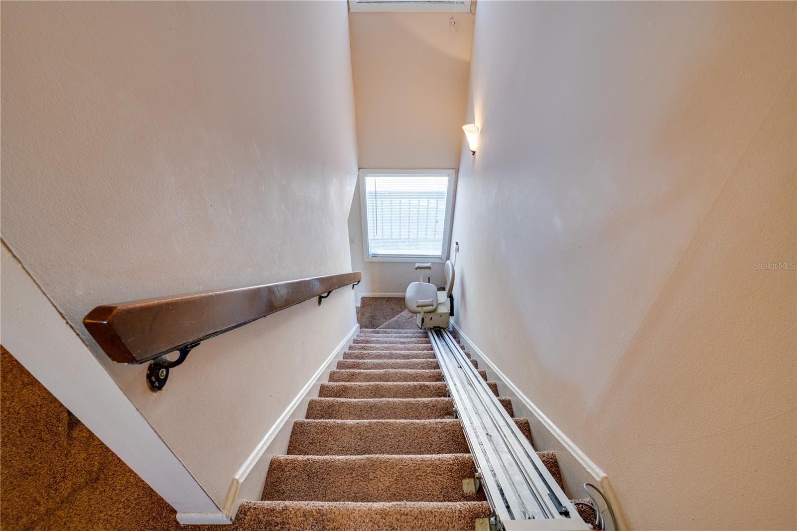 Stairs with chair lift going to Primary & Second Bedrooms - 6315 NEWTOWN CIR #15B3, TAMPA