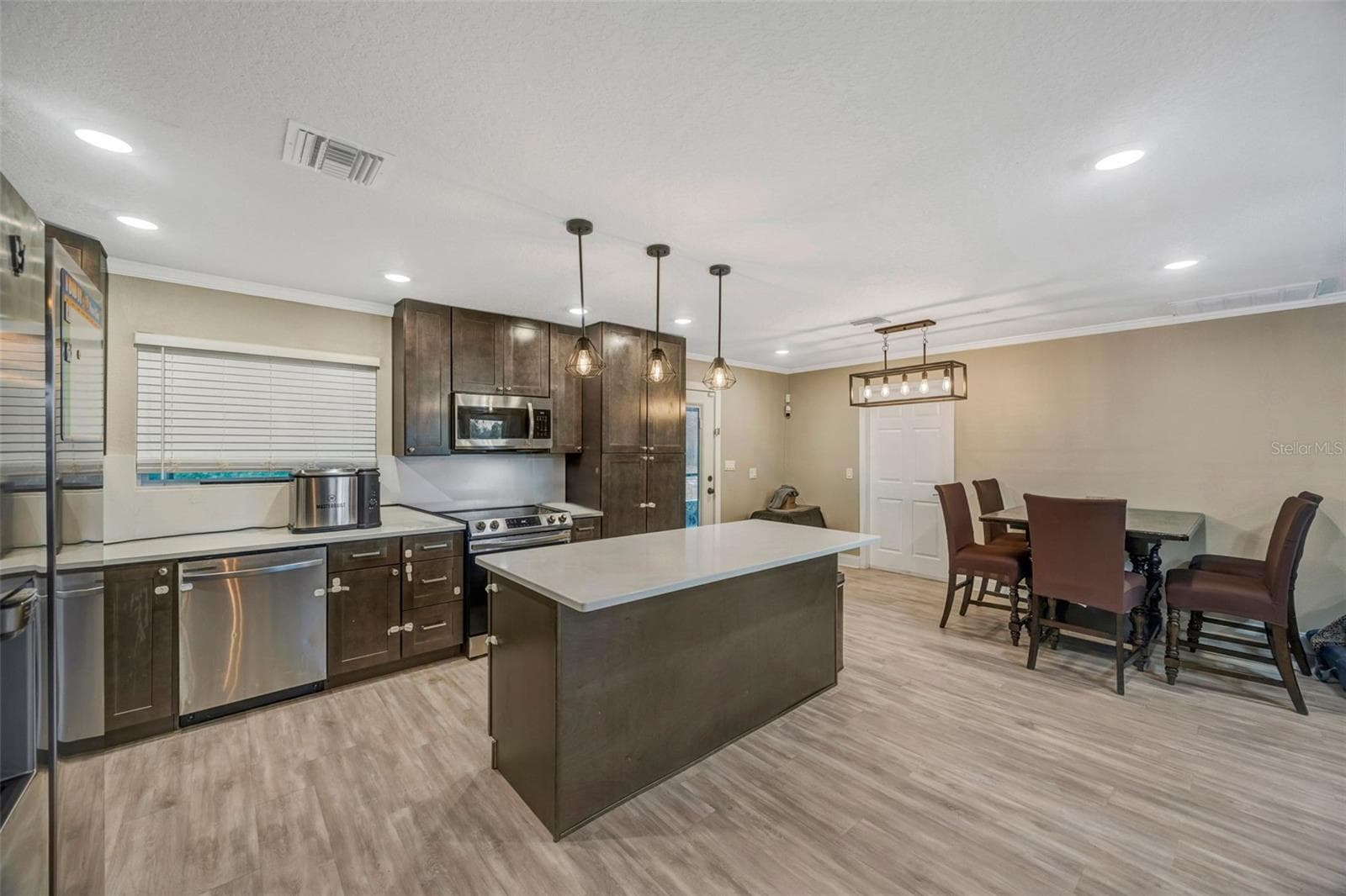 View of kitchen.dining from hallway - 7149 SPRUCE DR, WEEKI WACHEE