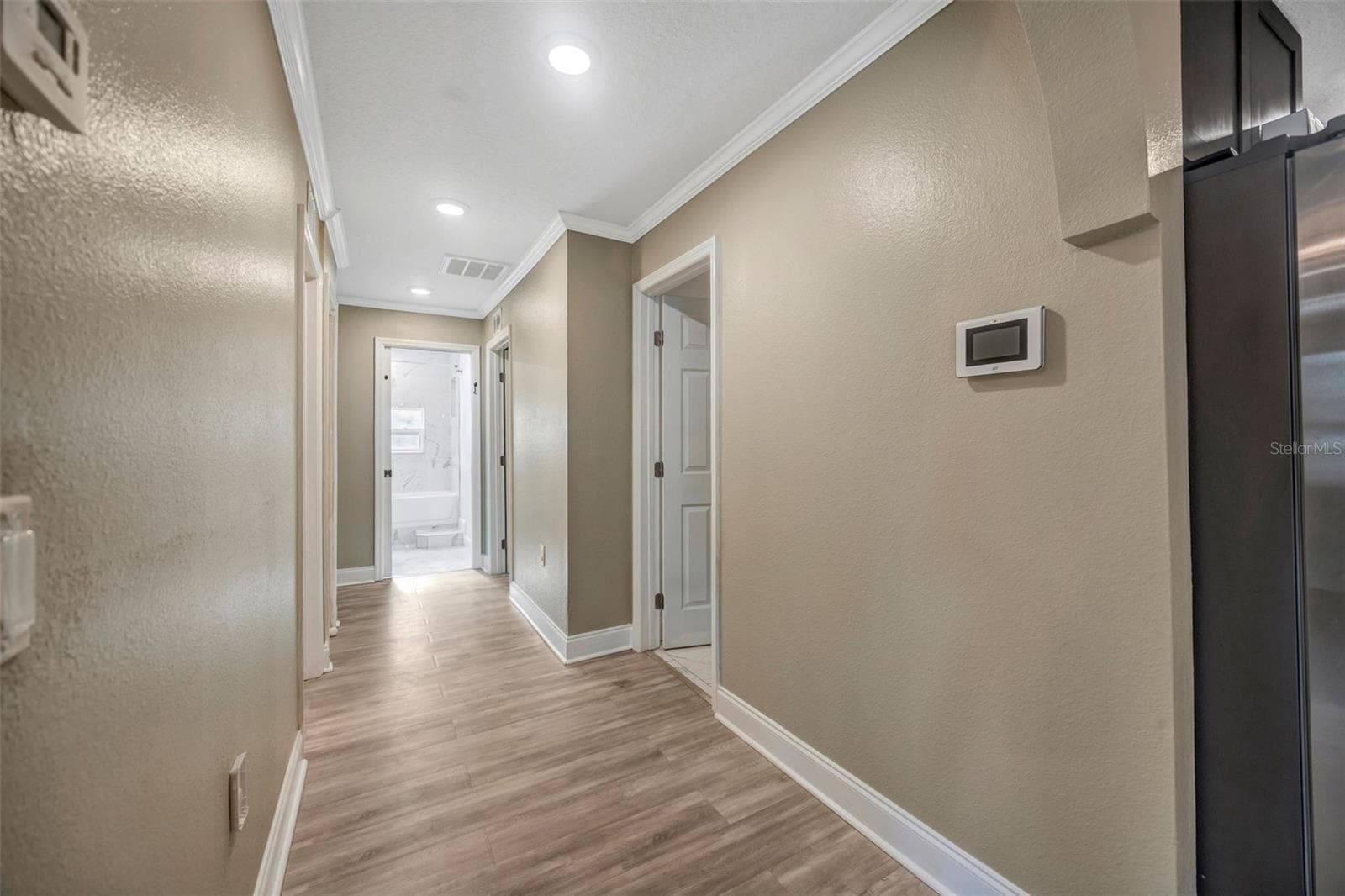 Hallway to bedrooms - 7149 SPRUCE DR, WEEKI WACHEE
