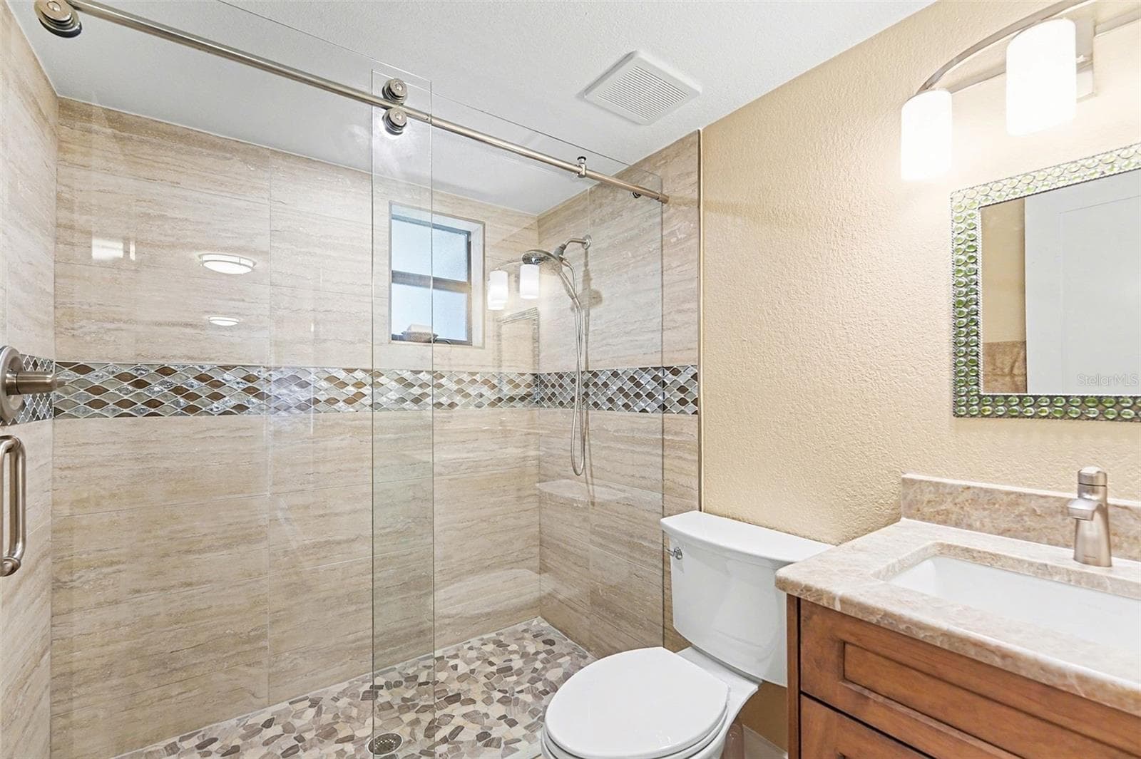 Second bathroom, updated with new countertop, flooring, and paint. - 19936 GULF BLVD, INDIAN SHORES