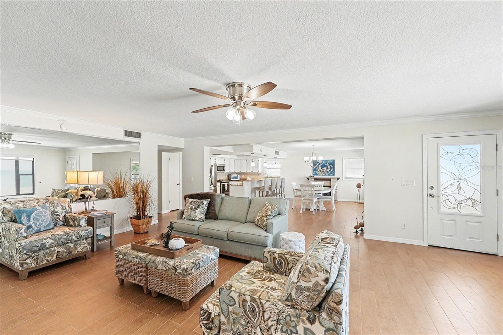 Enjoy the second level with its open design concept with a combined living room, kitchen, large dining room, and fireplace. Large picture windows are in each room with remote shades and frame the beautiful and unique sunsets each evening. - 19936 GULF BLVD, INDIAN SHORES
