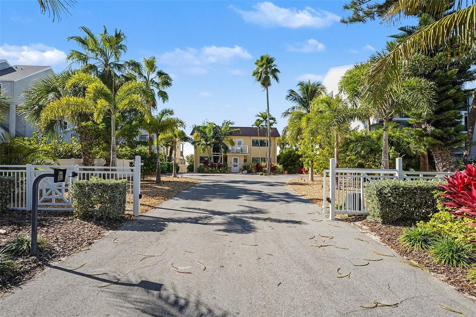 Welcome home through your private remote gate, a single coded entry for pedestrians and a remote coded gate for autos. - 19936 GULF BLVD, INDIAN SHORES