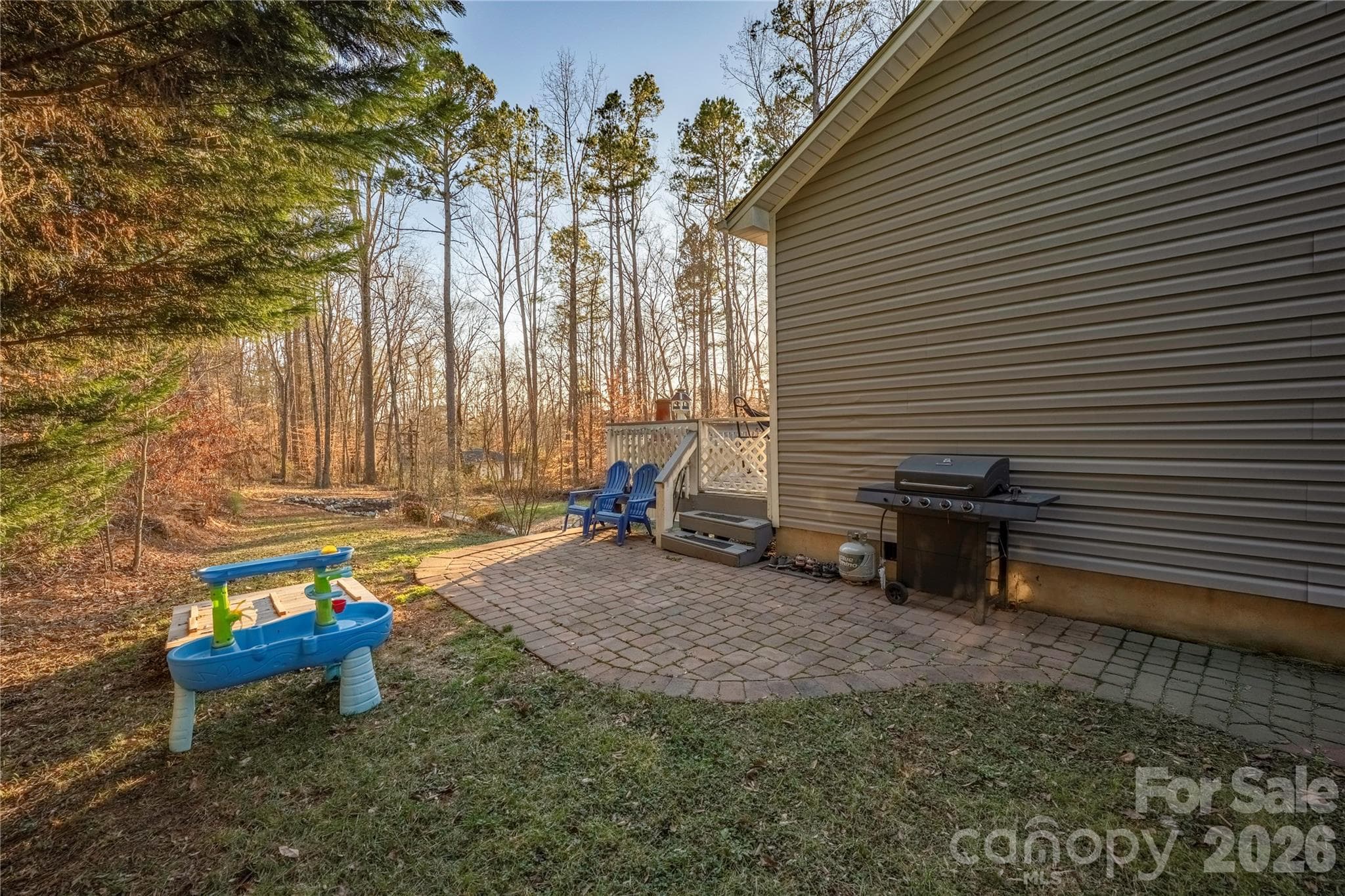 Paver patio wraps to the side of the house - 107 Barndale Drive, Troutman