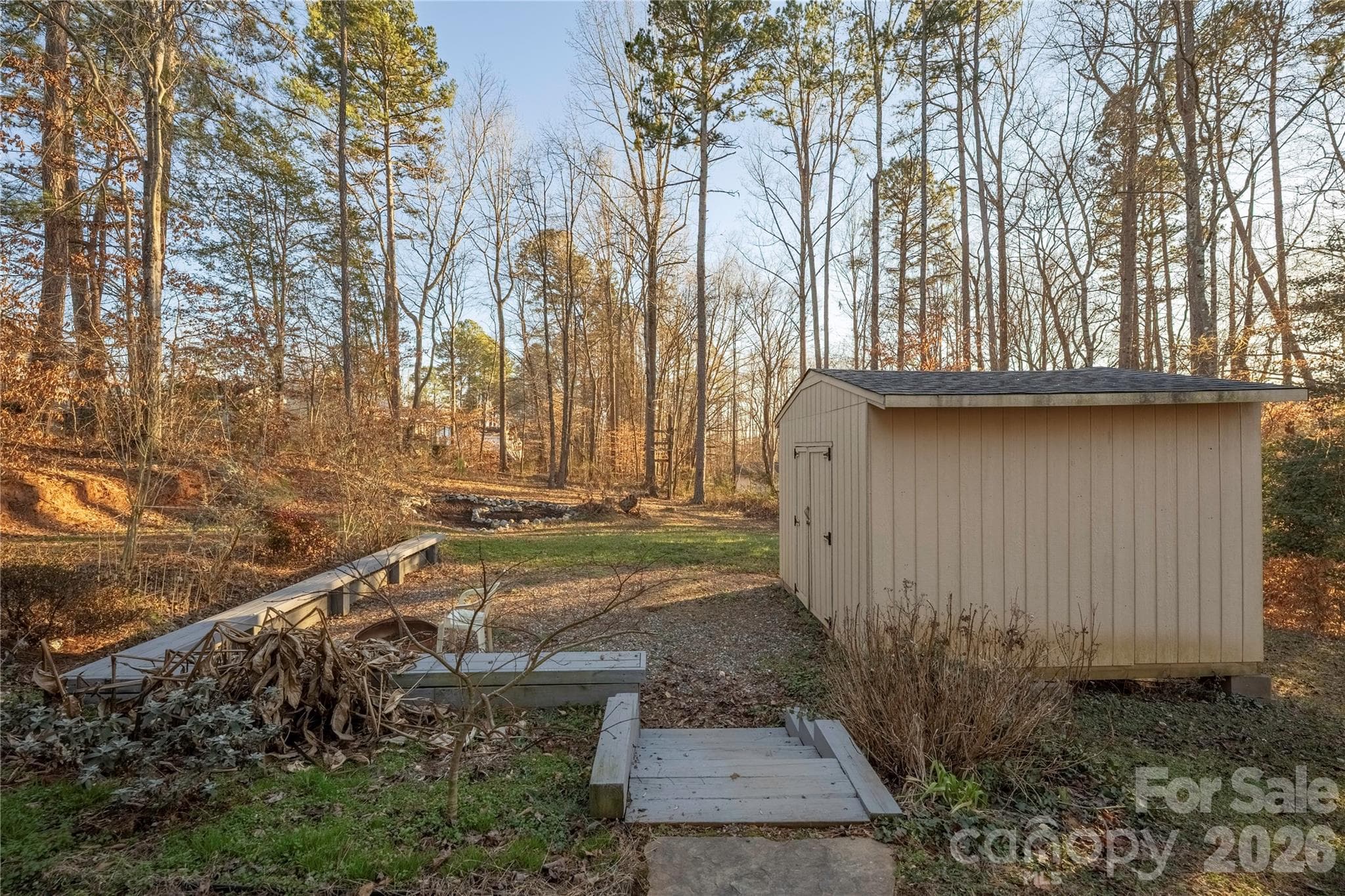 Large shed for storage and built in benches for a relaxing night around the fire pit. - 107 Barndale Drive, Troutman