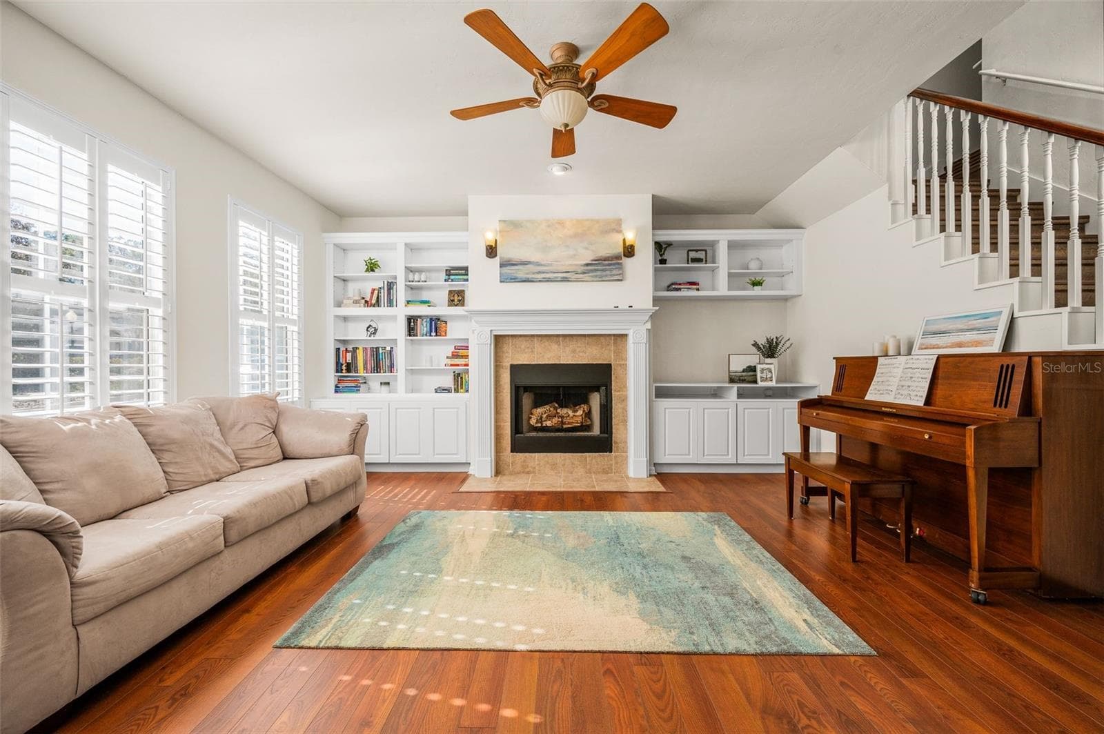 Great room with wood burning fireplace, built-ins and planation shutters - 11550 NW 17TH PL, GAINESVILLE