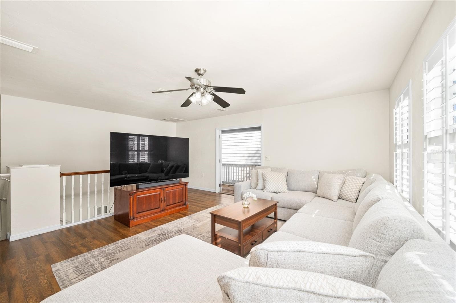 Multi-purpose bonus room upstairs with updated flooring and balcony access - 11550 NW 17TH PL, GAINESVILLE