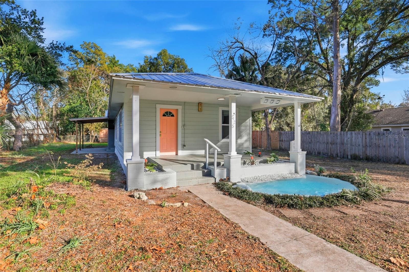 USDA eligible - 100% financing available. Charming front elevation with covered porch and decorative pond - 425 SE 2ND ST, WILLISTON