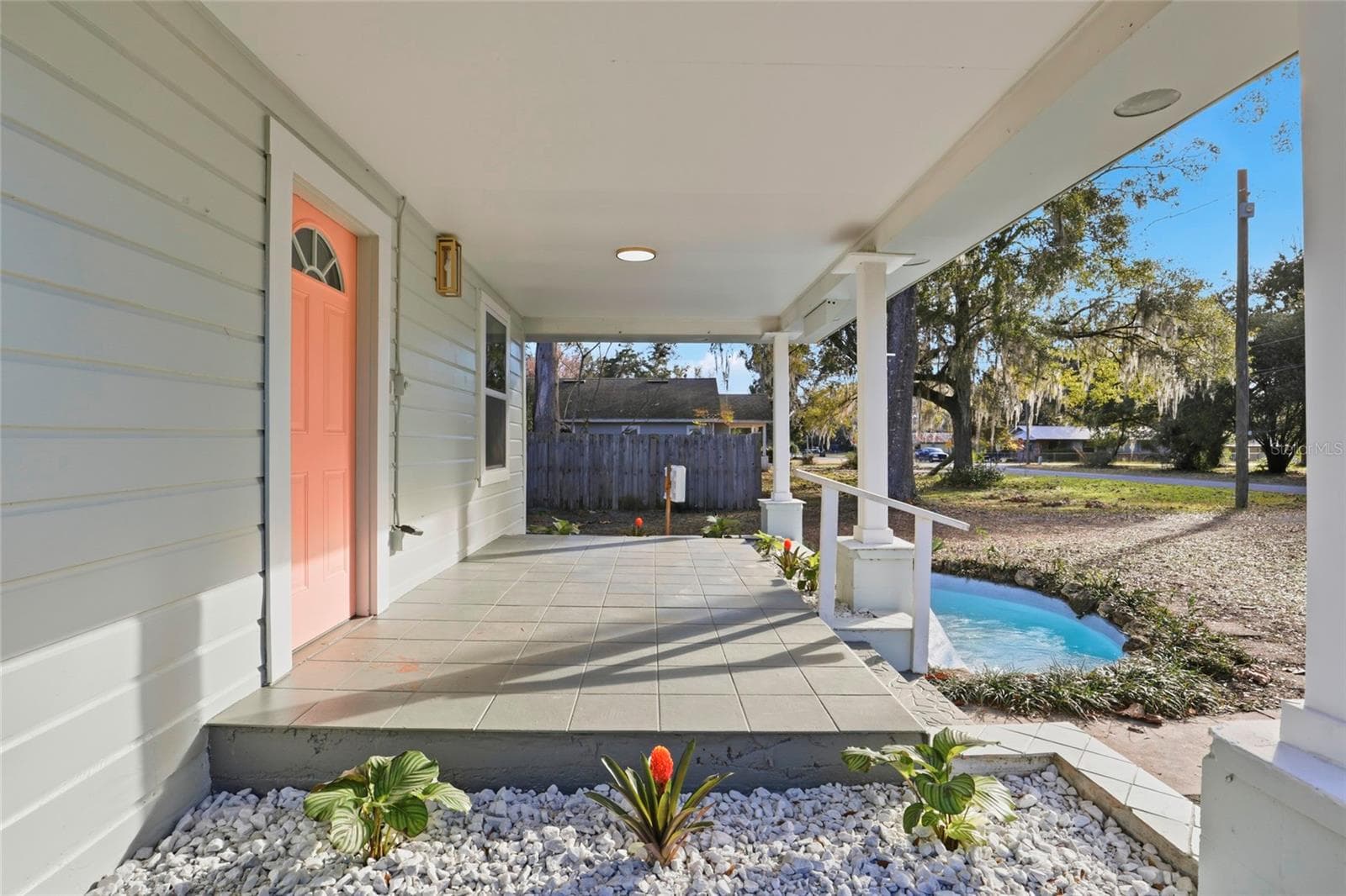Covered front porch overlooking the decorative pond - perfect spot to relax - 425 SE 2ND ST, WILLISTON