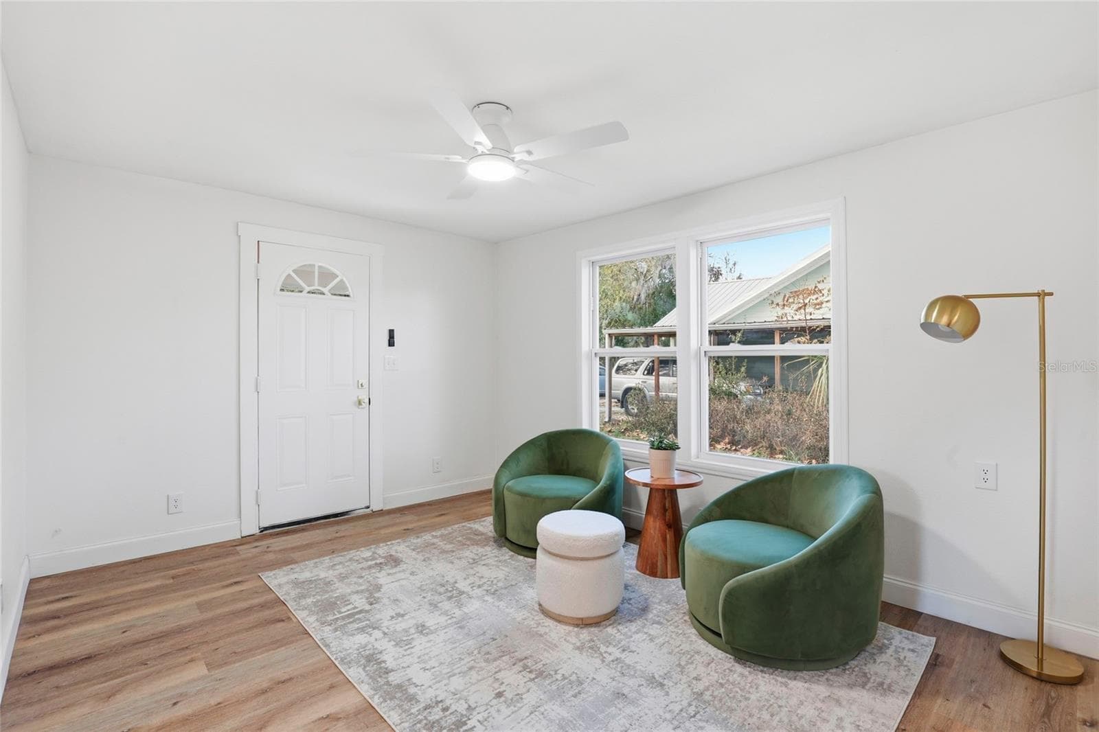 Bright front living room with new LVP flooring and fresh paint throughout - 425 SE 2ND ST, WILLISTON
